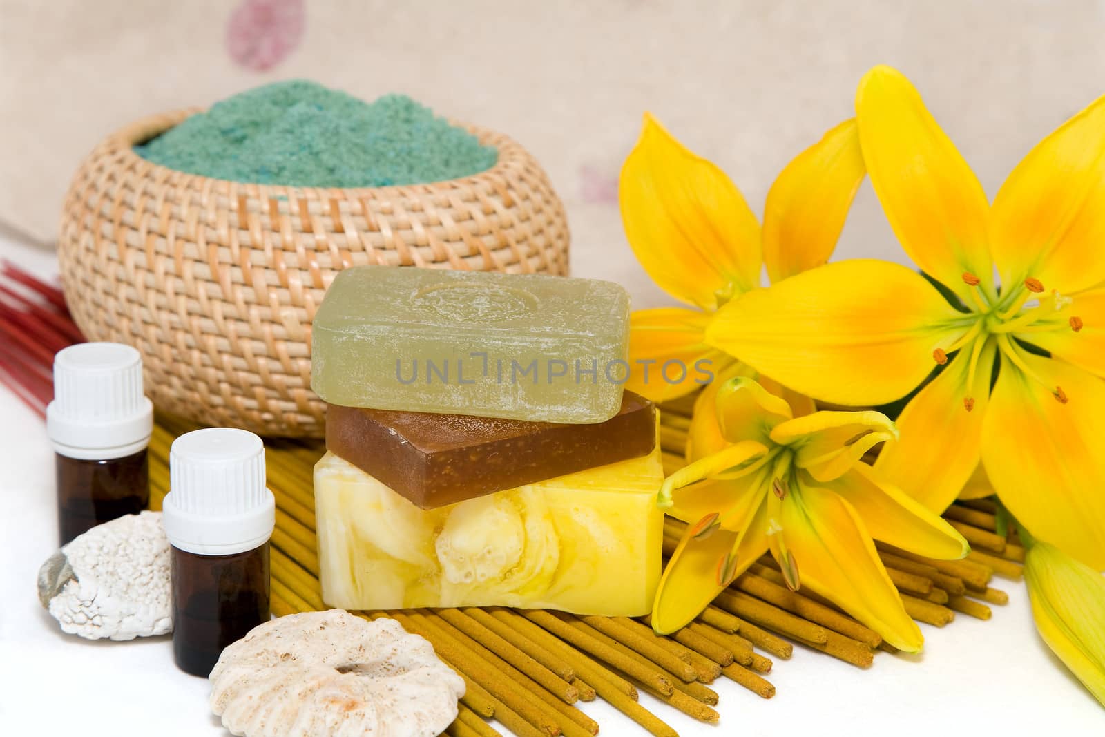 soap with natural ingredients , flowers an bottles of aromatic oil 