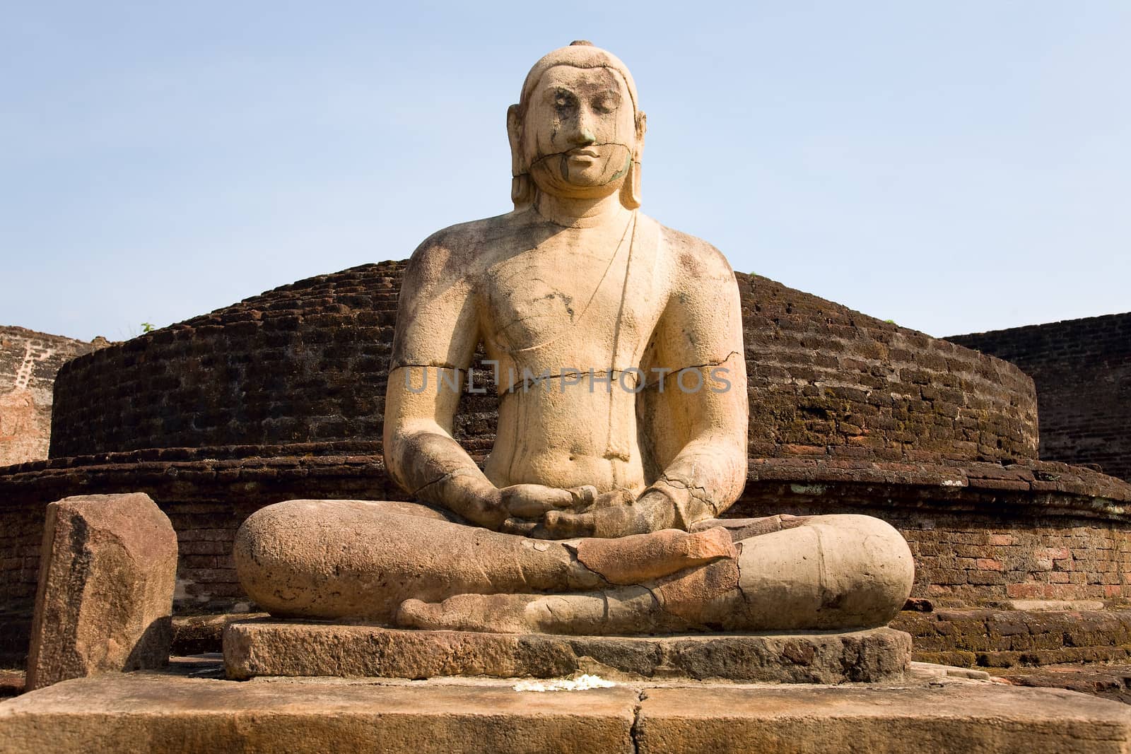 Ancient Buddha statue with blue sky on background  at Vatadage temple in Pollonnaruwa, Sri Lanka 