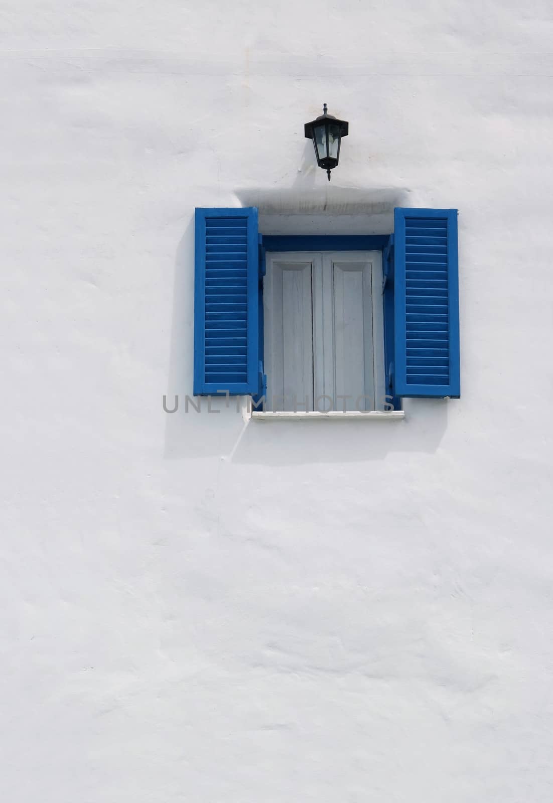  blue window on the white wall  by opasstudio