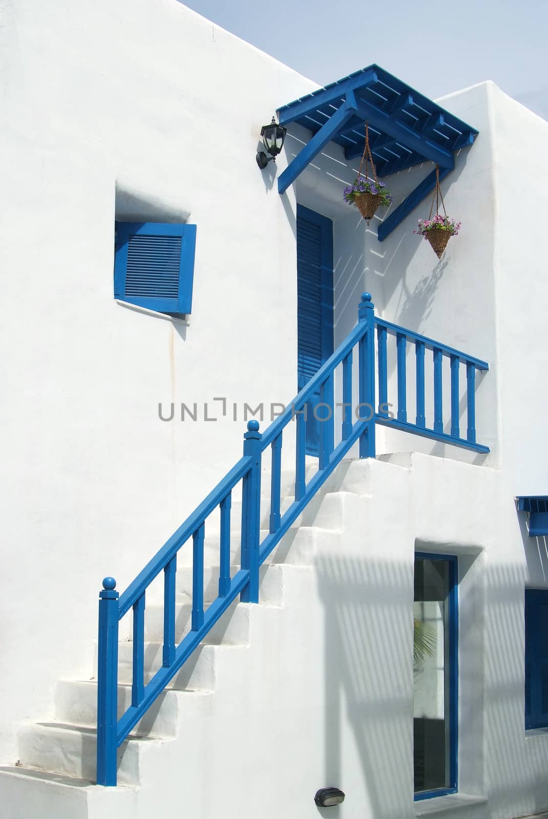 Vintage blue window on the white wall 