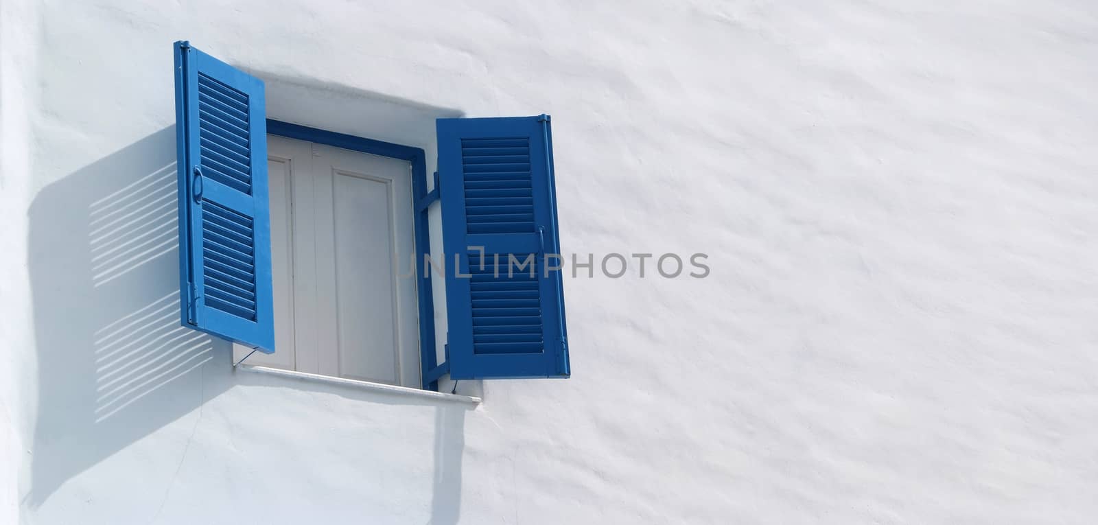 Vintage blue window on the white wall 