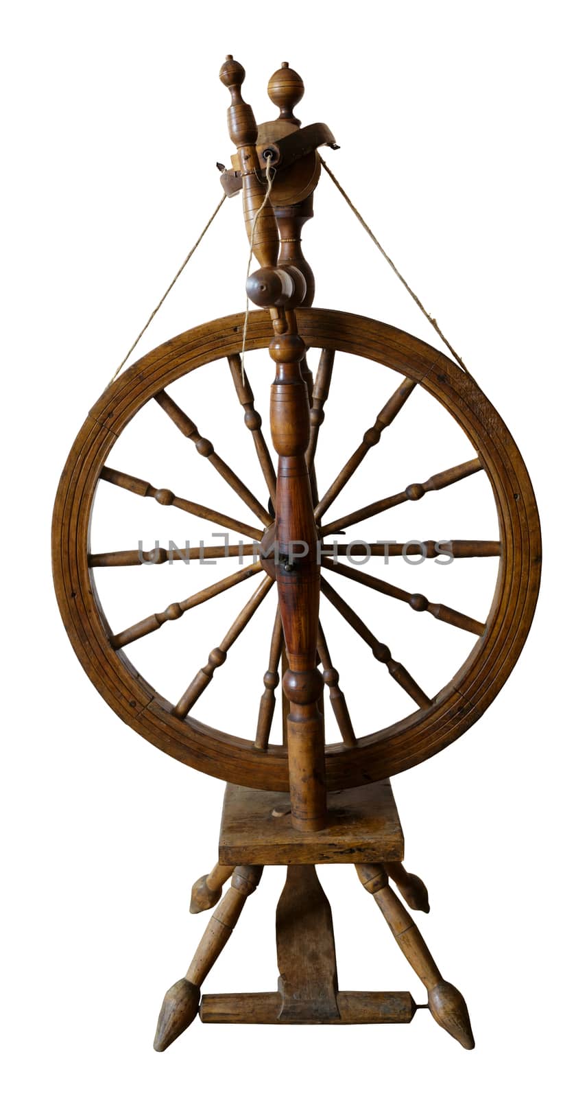 Old spinning wheel against white background
