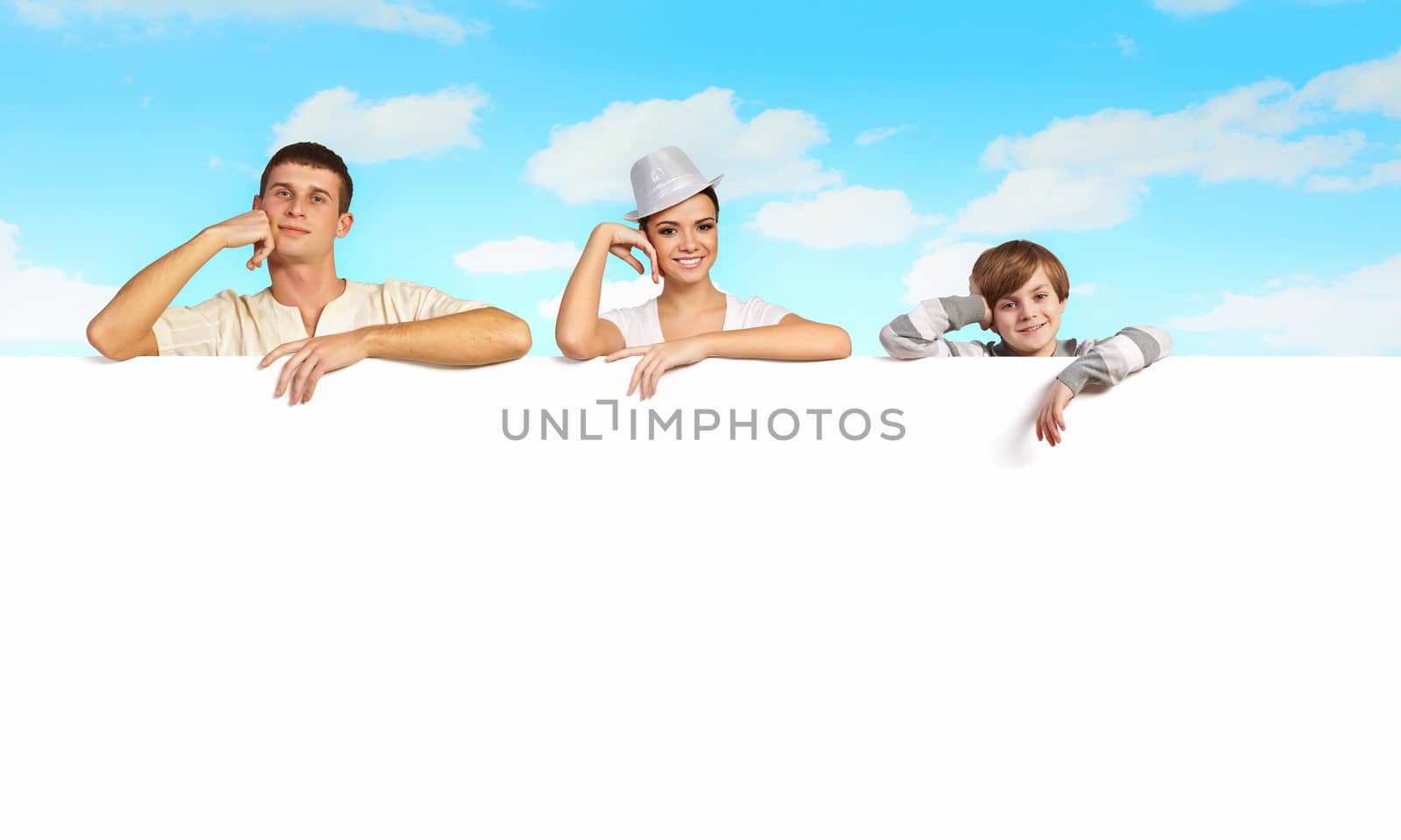 Happy young family with blank banner. Place for text