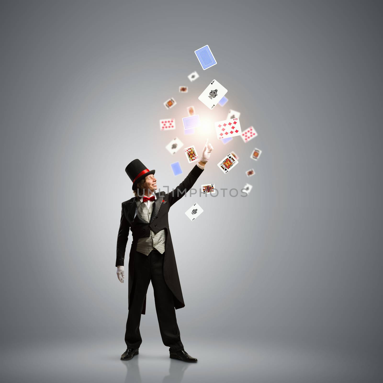 Image of magician in hat with deck of cards