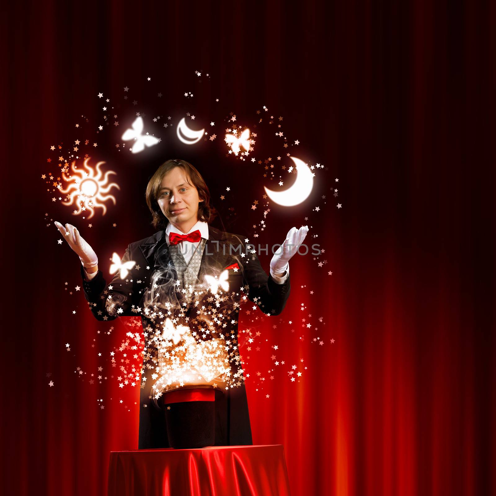 Image of magician holding hat with lights and fumes going out