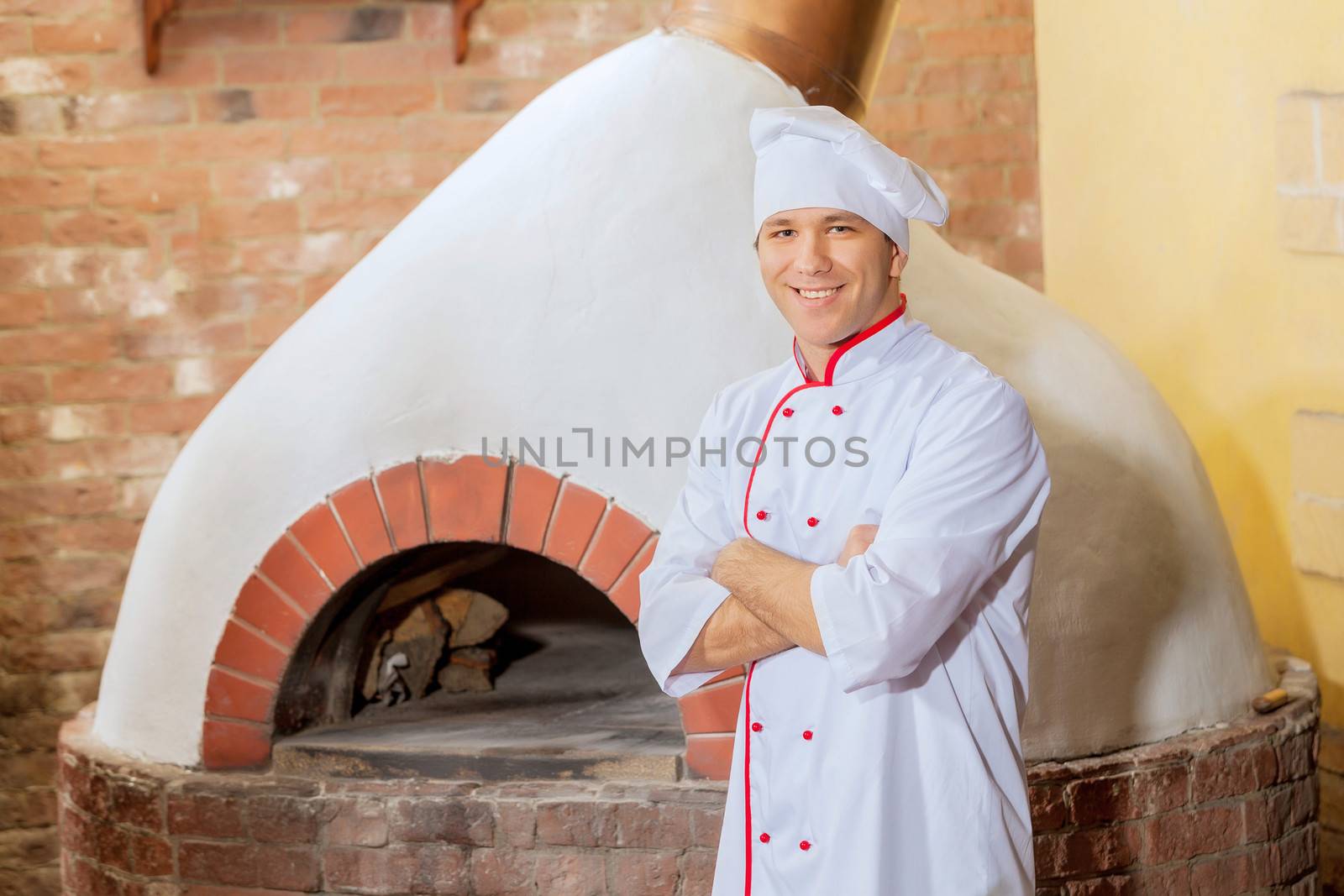 Image of young handsome male cook at kitchen