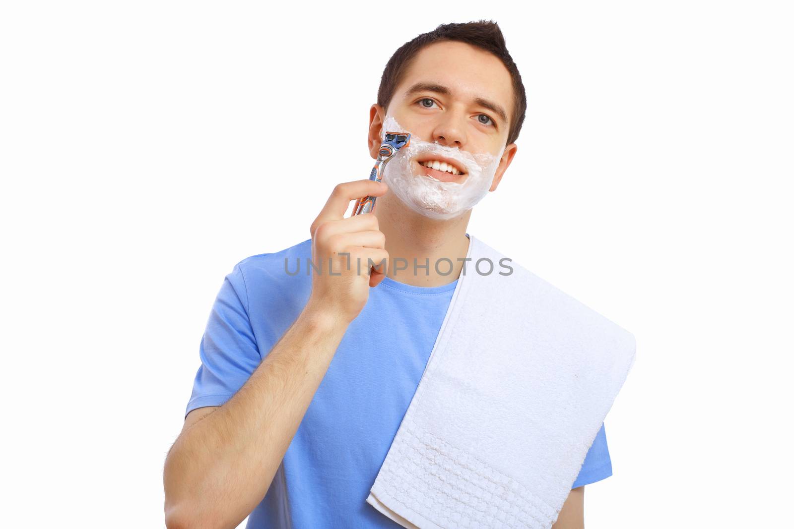 Young man at home shaving himself in the morning