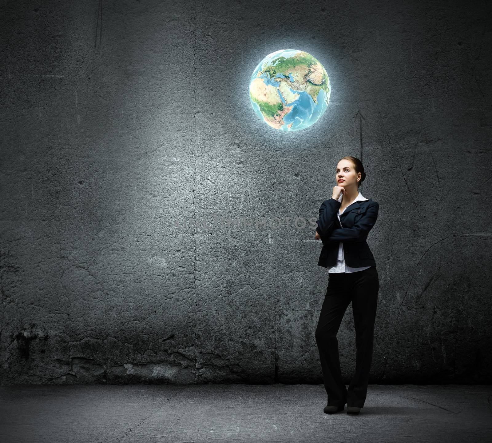 Image of thoughtful businesswoman looking at planet earth