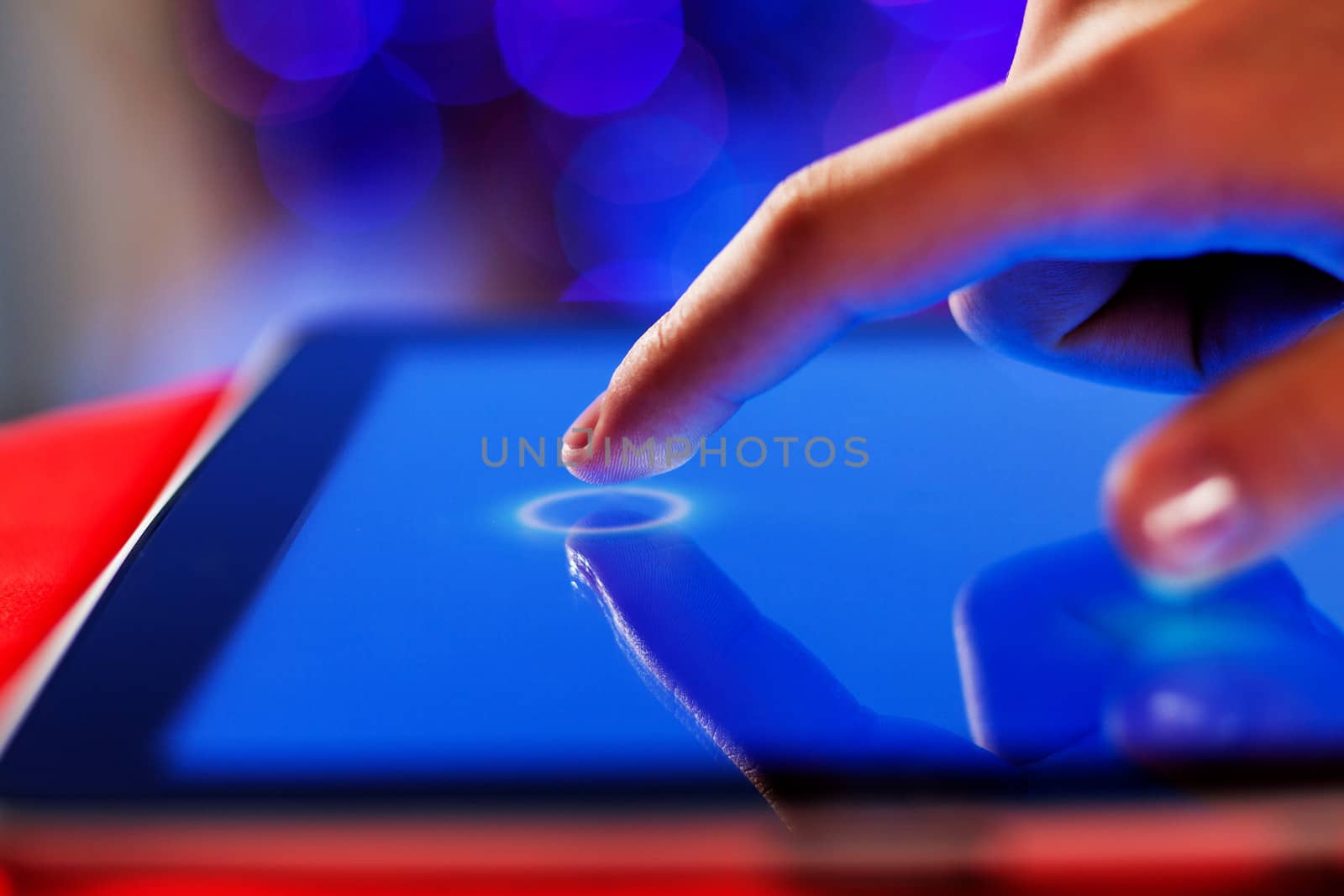 Close-up image of finger touching blue screen