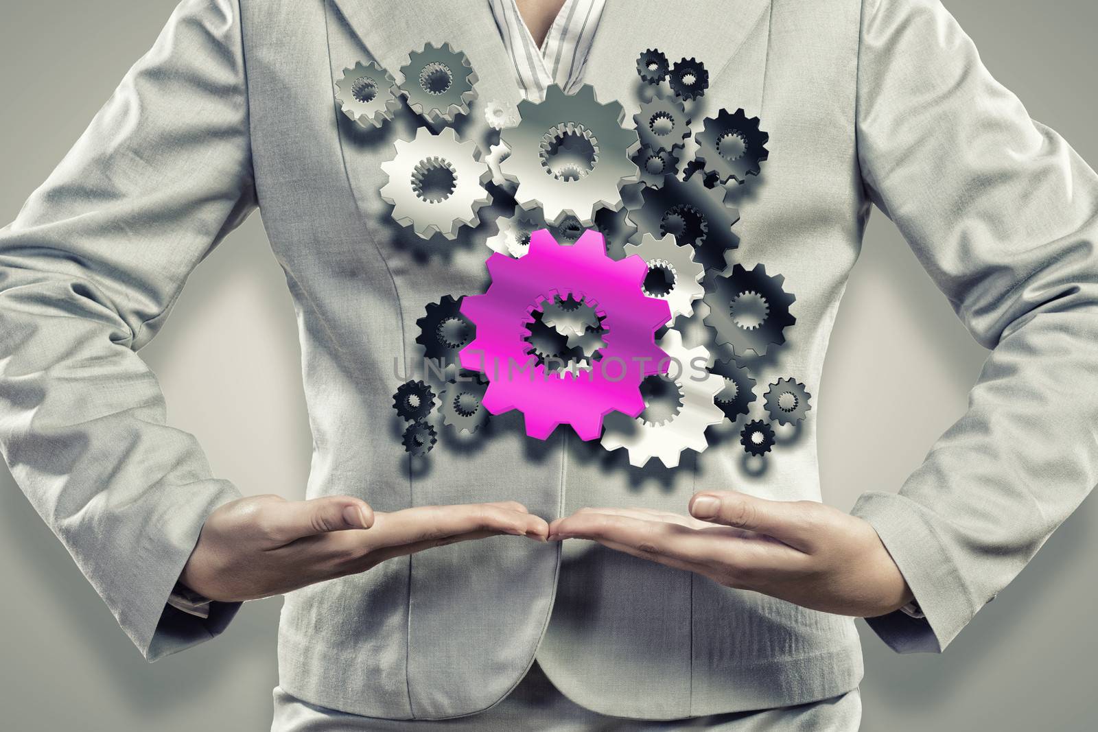 Close up image of businesswoman holding gears in hands
