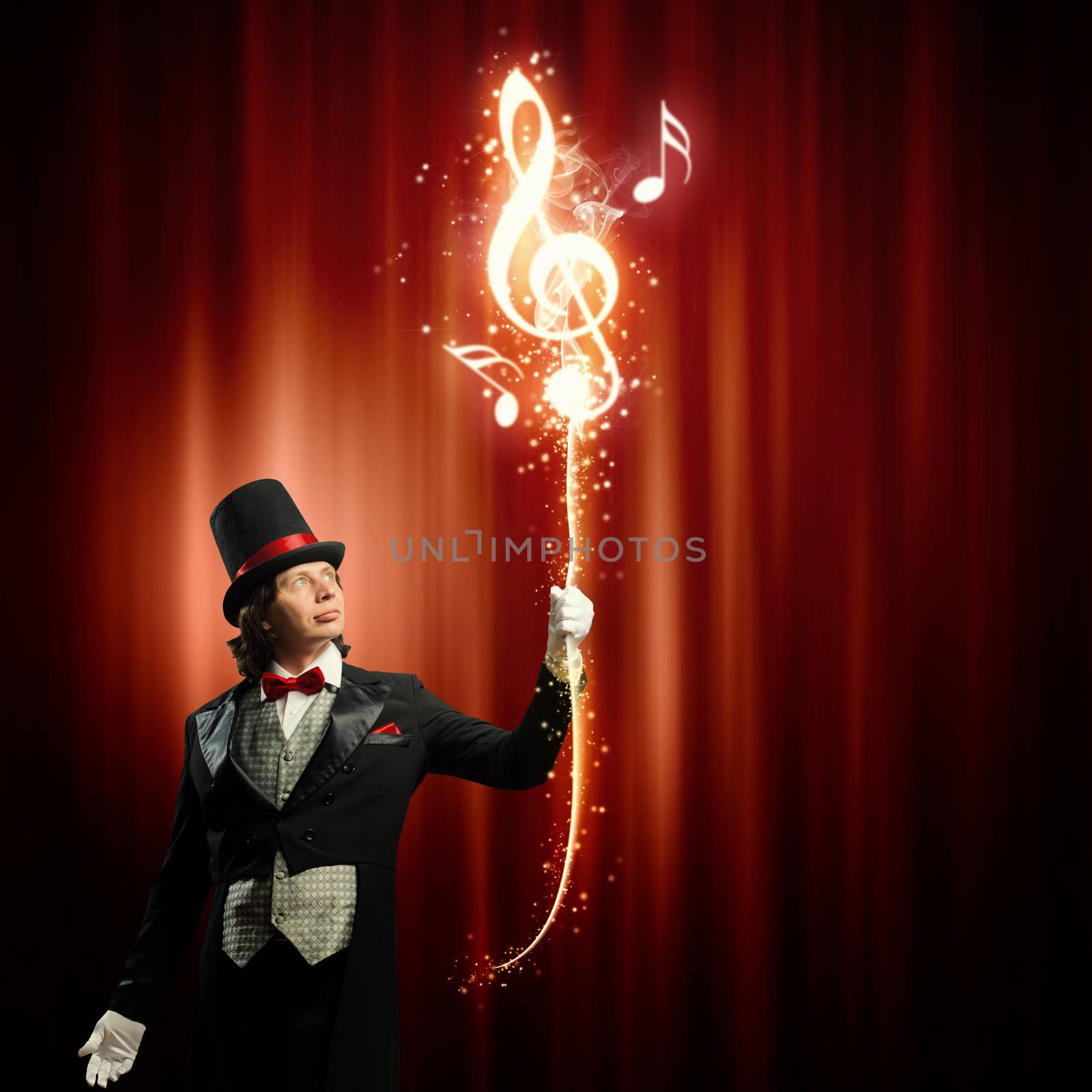 Image of man magician showing trick against color background