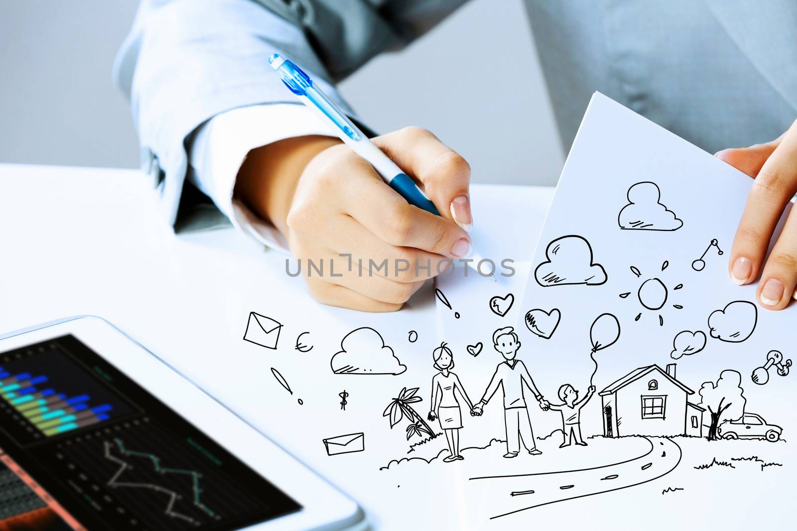 Image of businesswoman sitting at table and drawing sketch