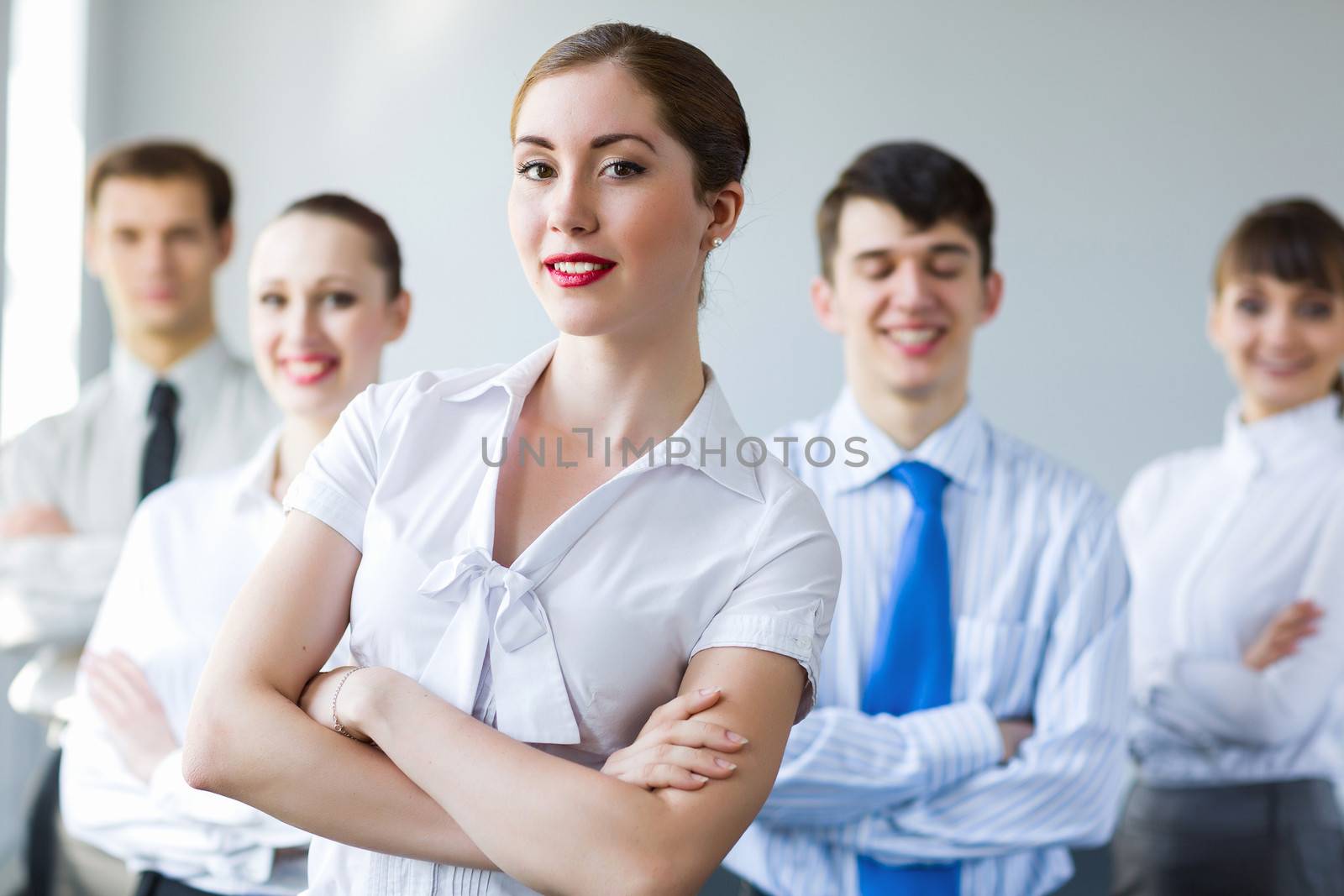 Young smiling businesswoman with colleagues. Leadership concept