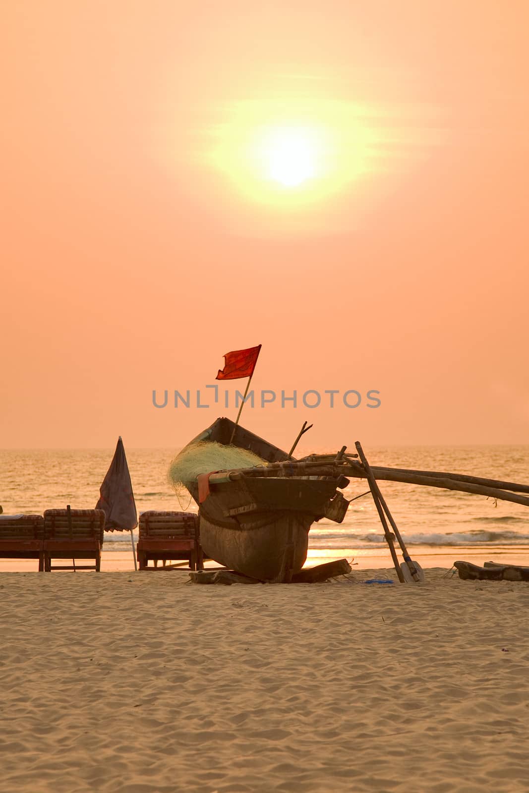  indian boat at sunset at Arambol beach, Goa, India