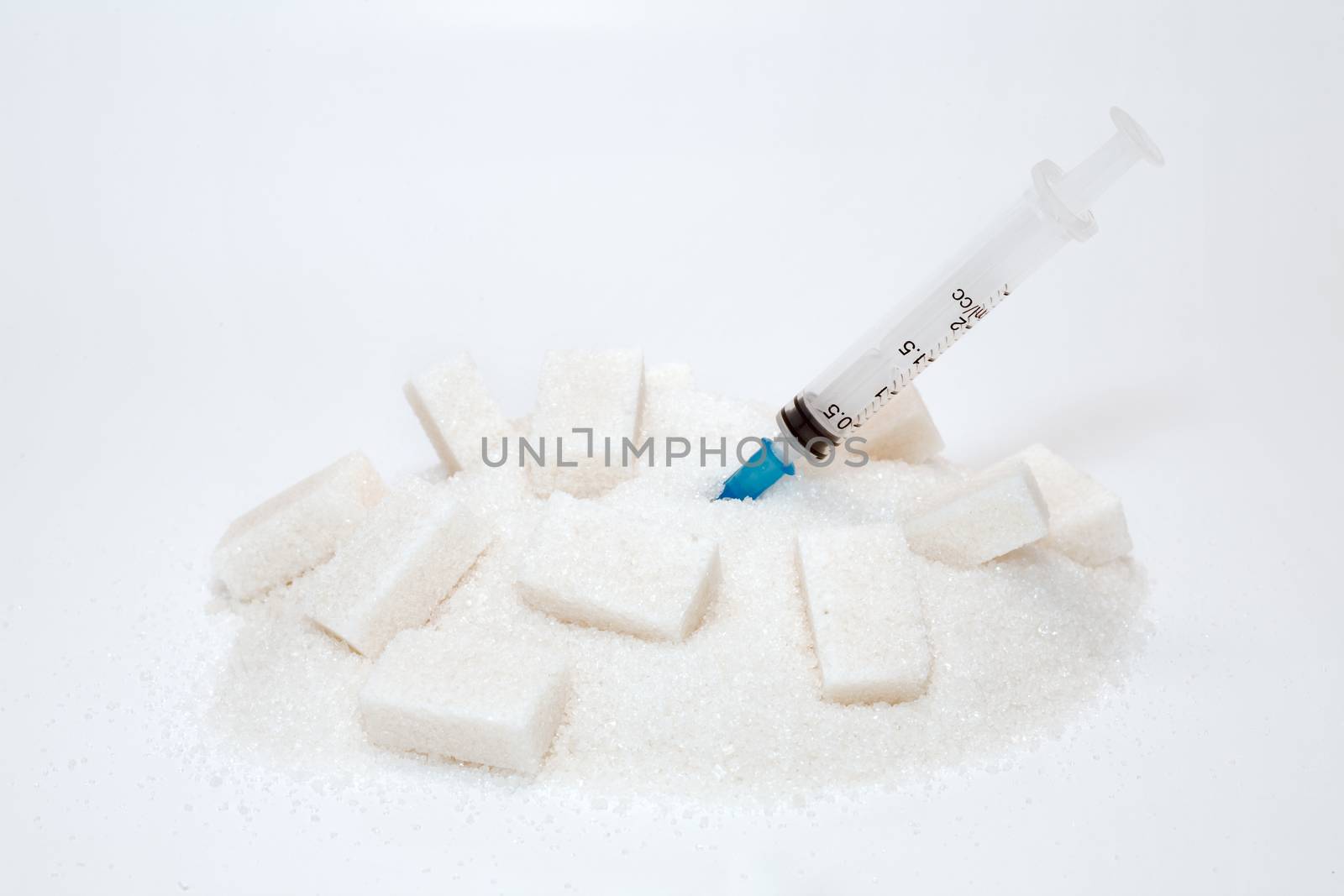 syringe with gradient force into heap of sugar