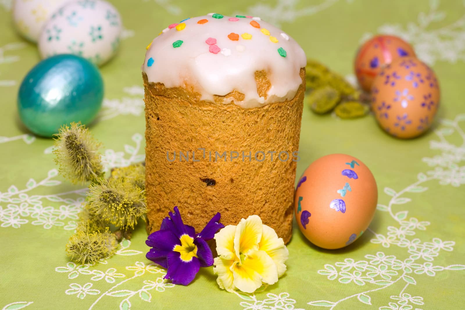 Easter cake with glace icing and colored easter eggs 