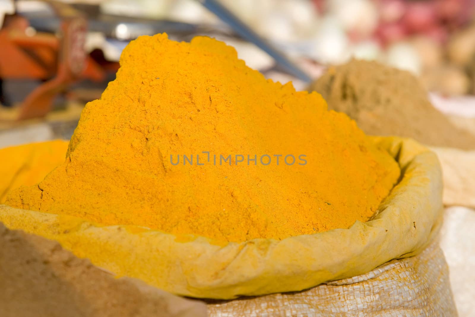 Turmeric powder spice pile  by foryouinf