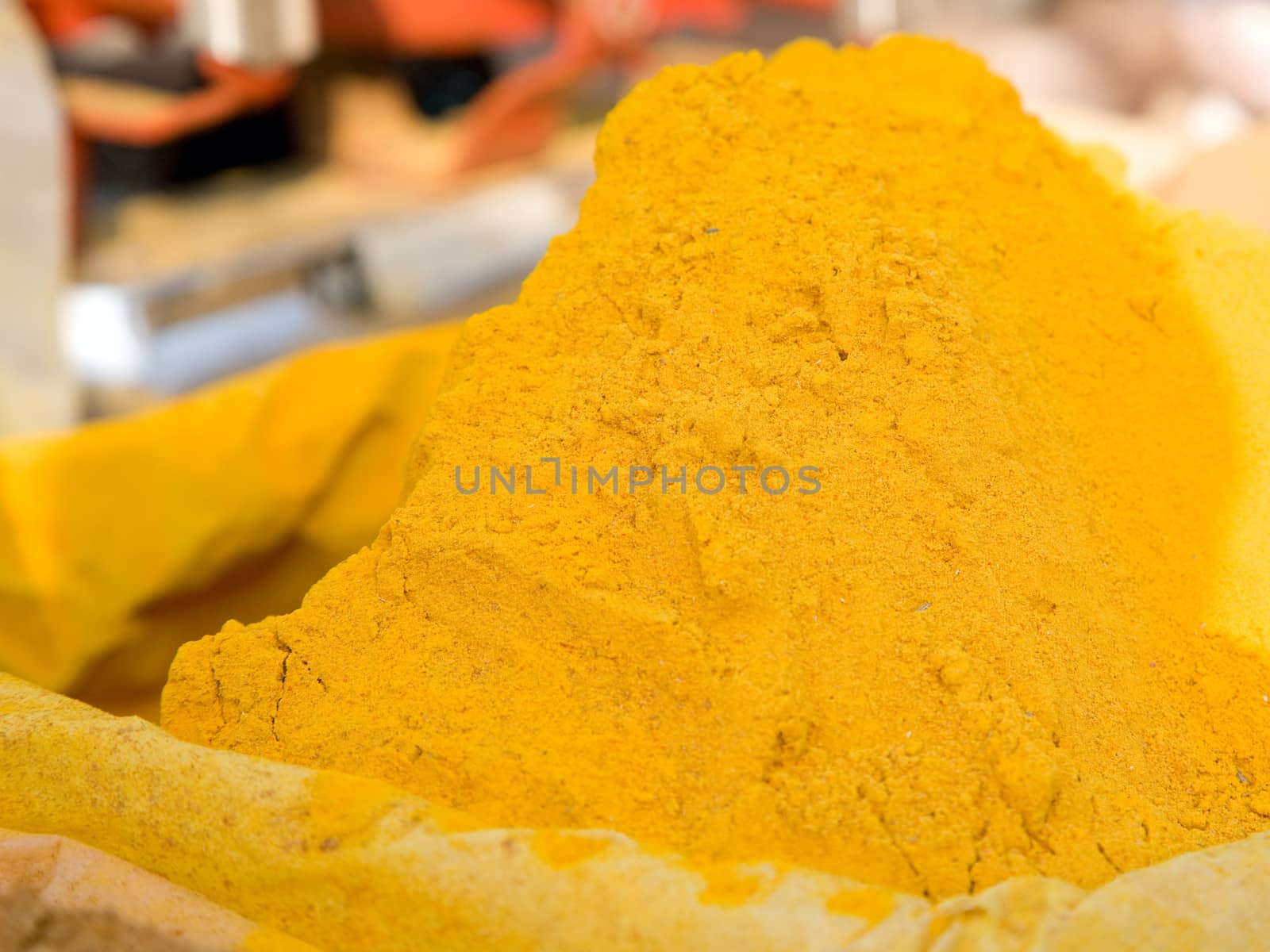 Turmeric powder spice pile by foryouinf