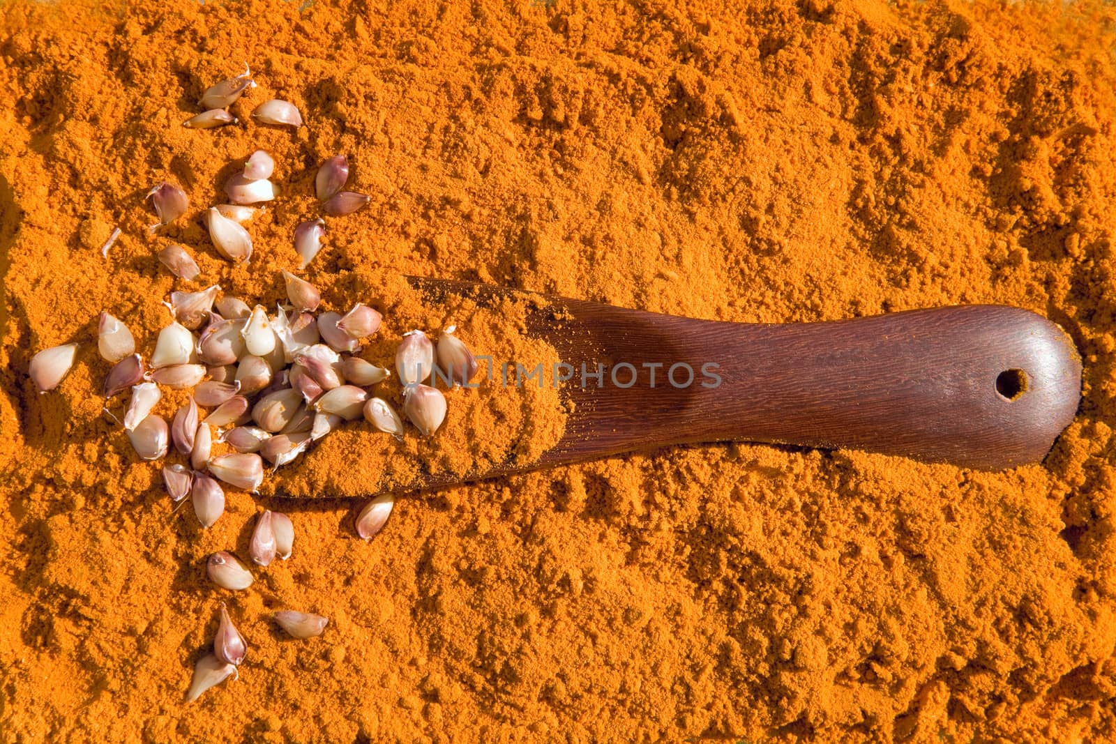 Turmeric  with  garlic and spoon by foryouinf