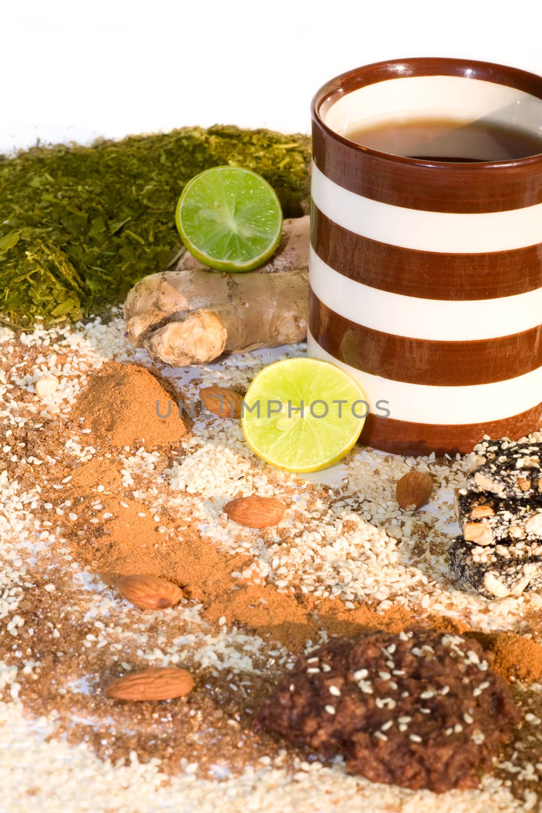cup of tea with ingredients for tea, and cookies  on a white background