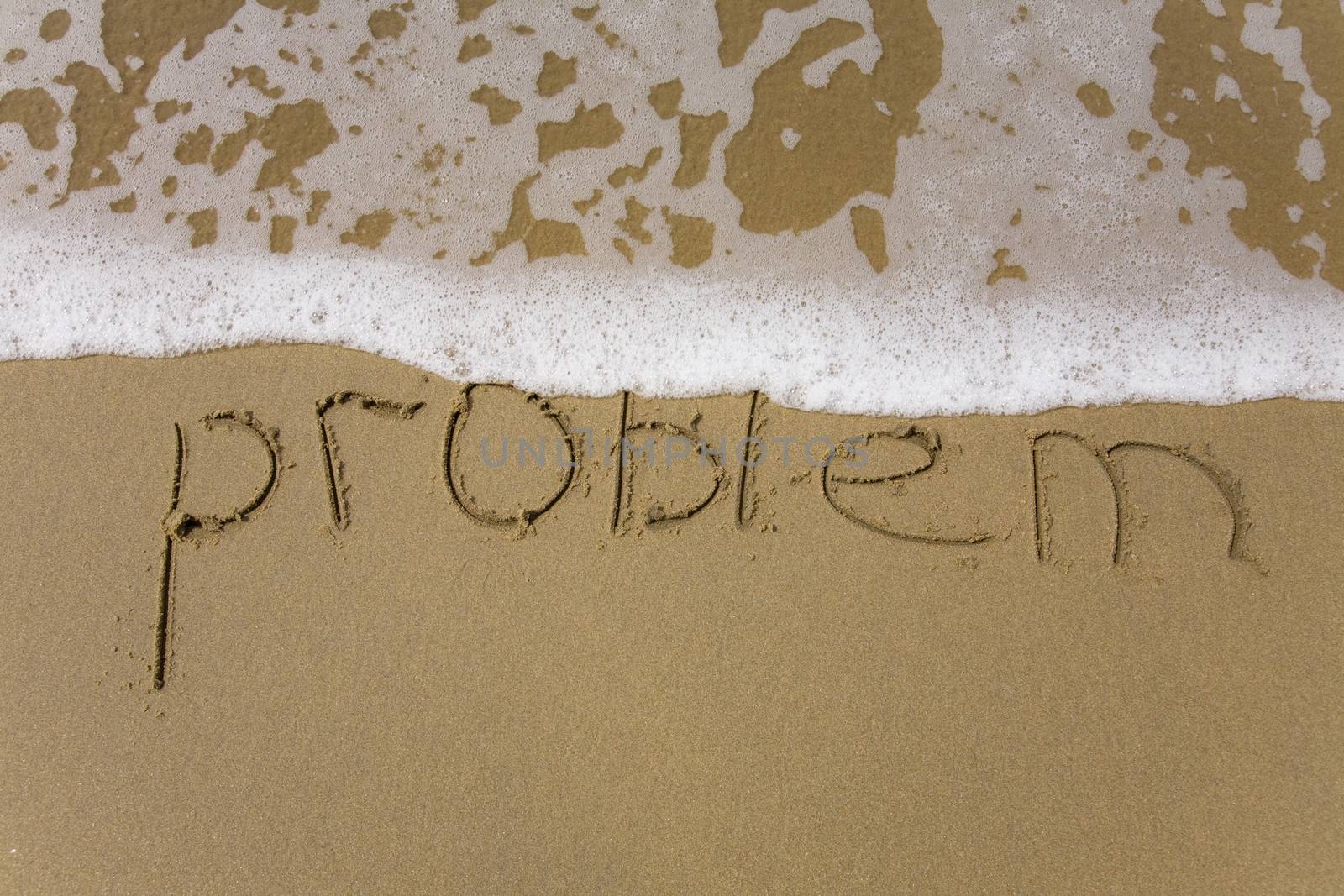 Handwriting word problem  written  in the sand