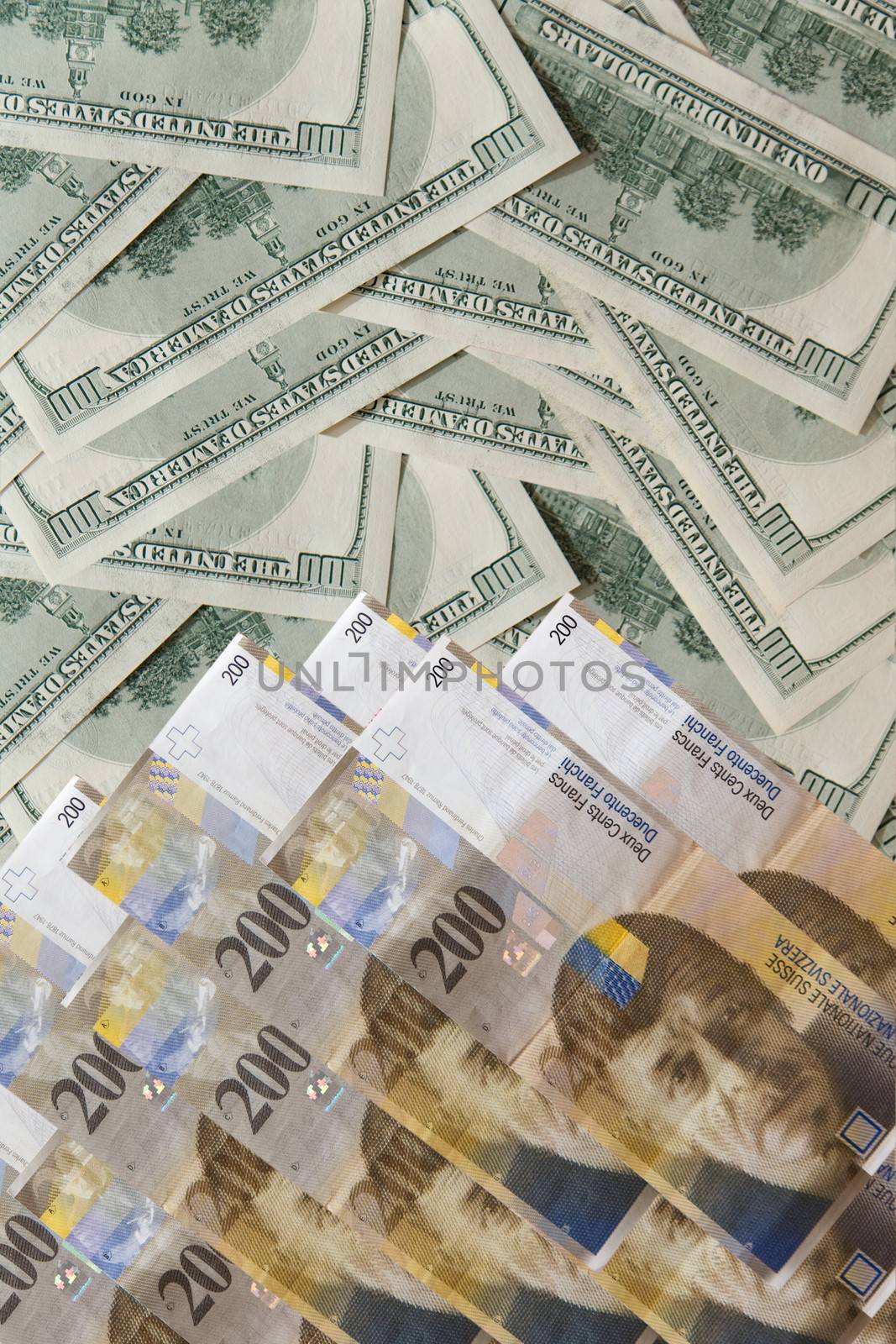 Image pile of banknotes - u.s. dollars and Swiss francs