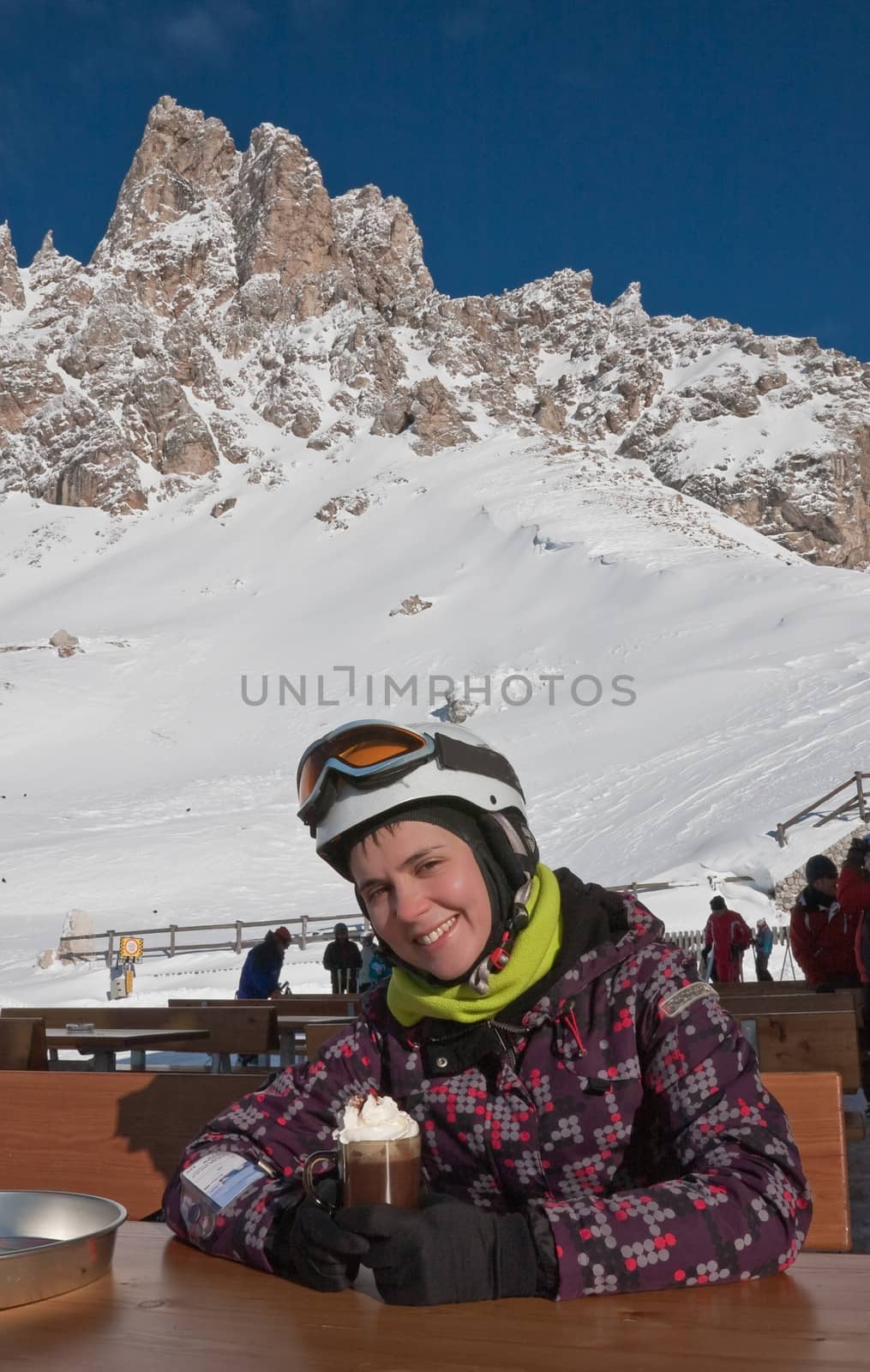 The girl at the table mountain cafe. Ski resort of Selva di Val Gardena, Italy