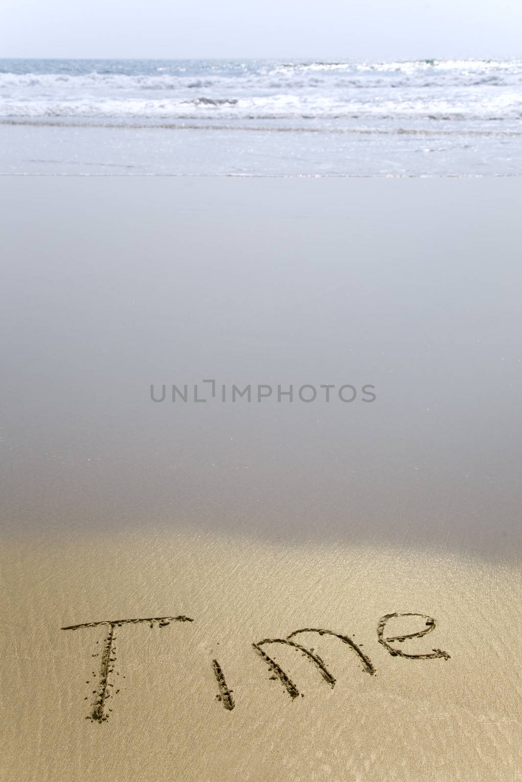 Handwriting word Time written  in the sand