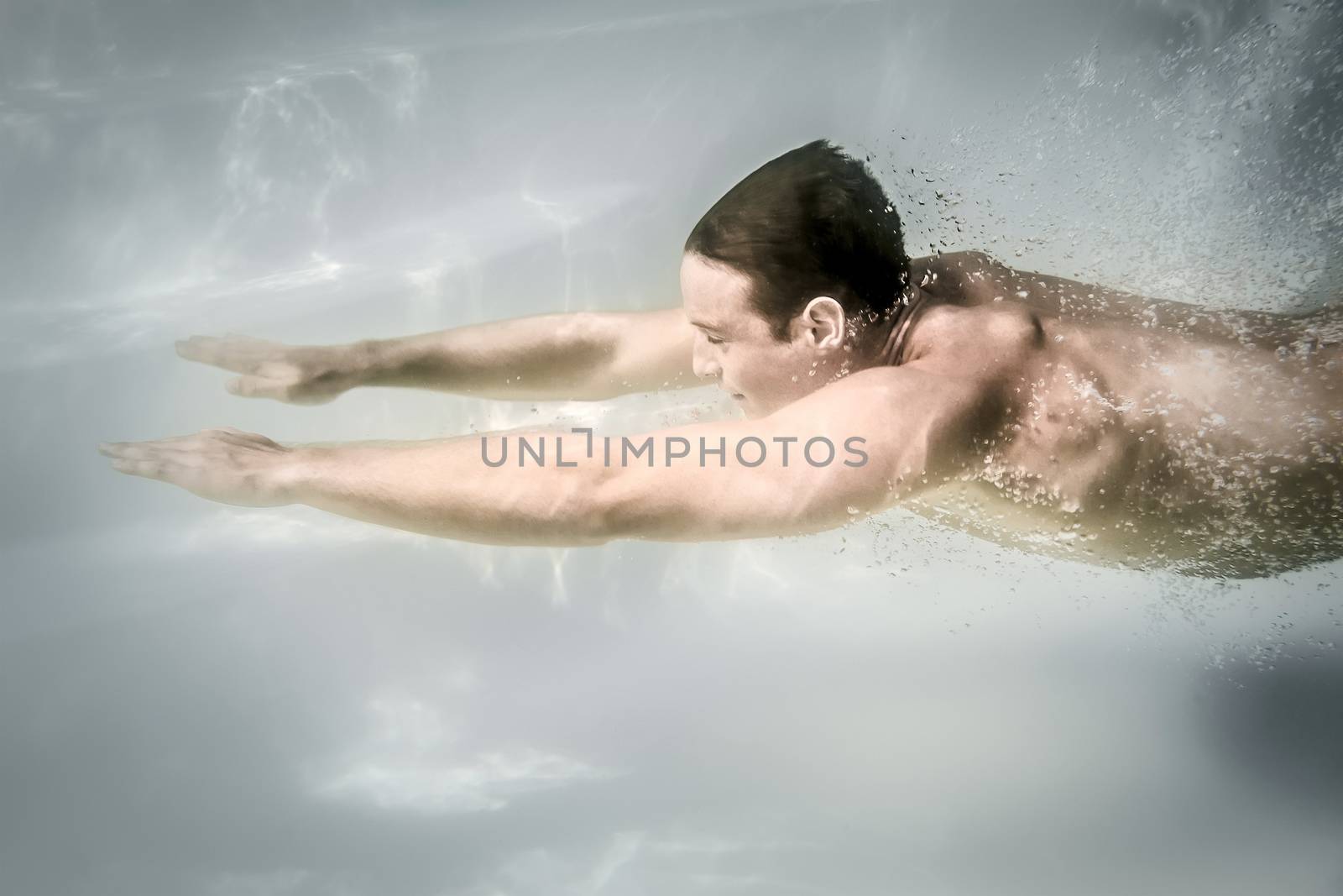 An image of a man diving in a pool