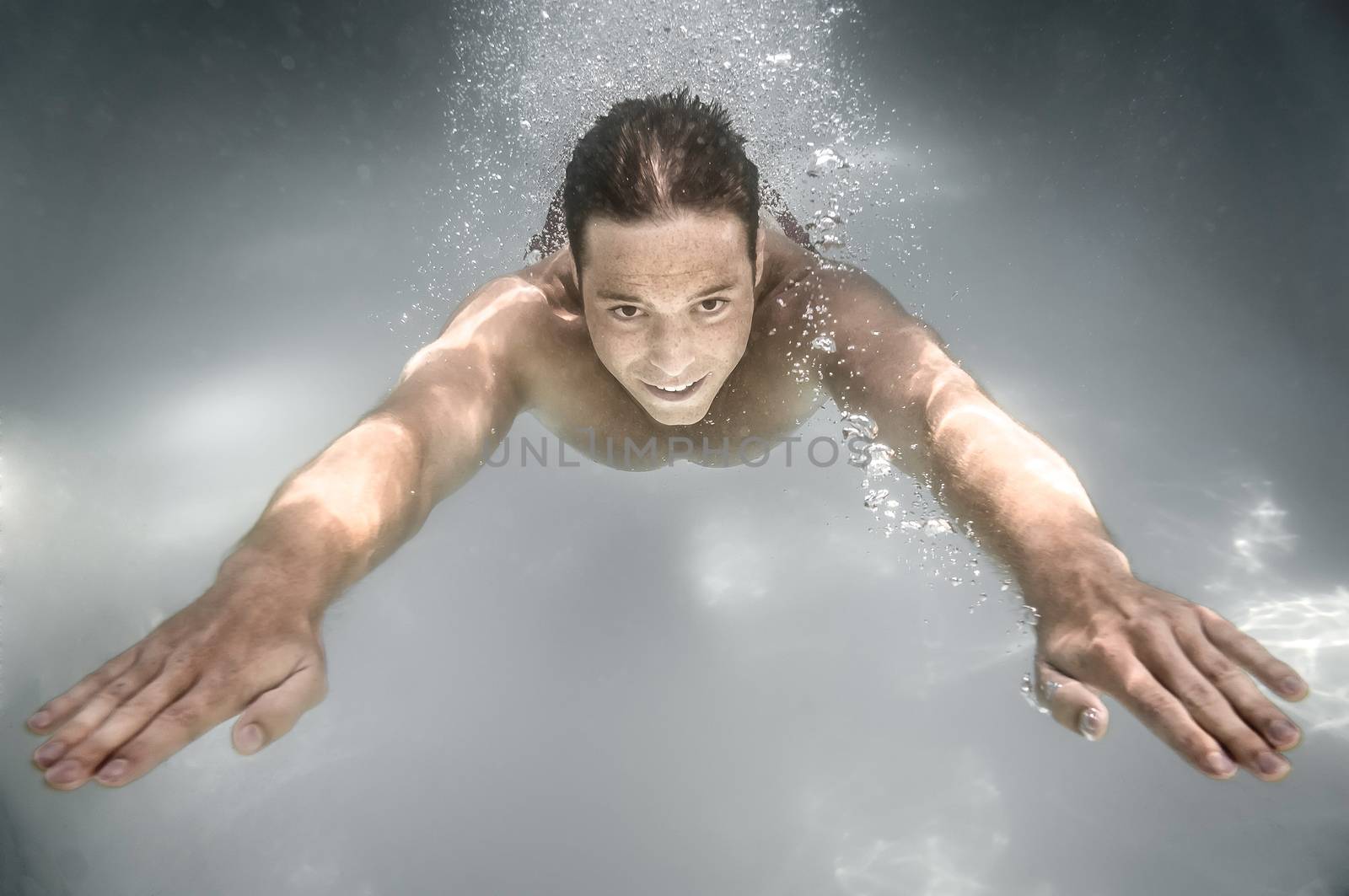 An image of a man diving in a pool