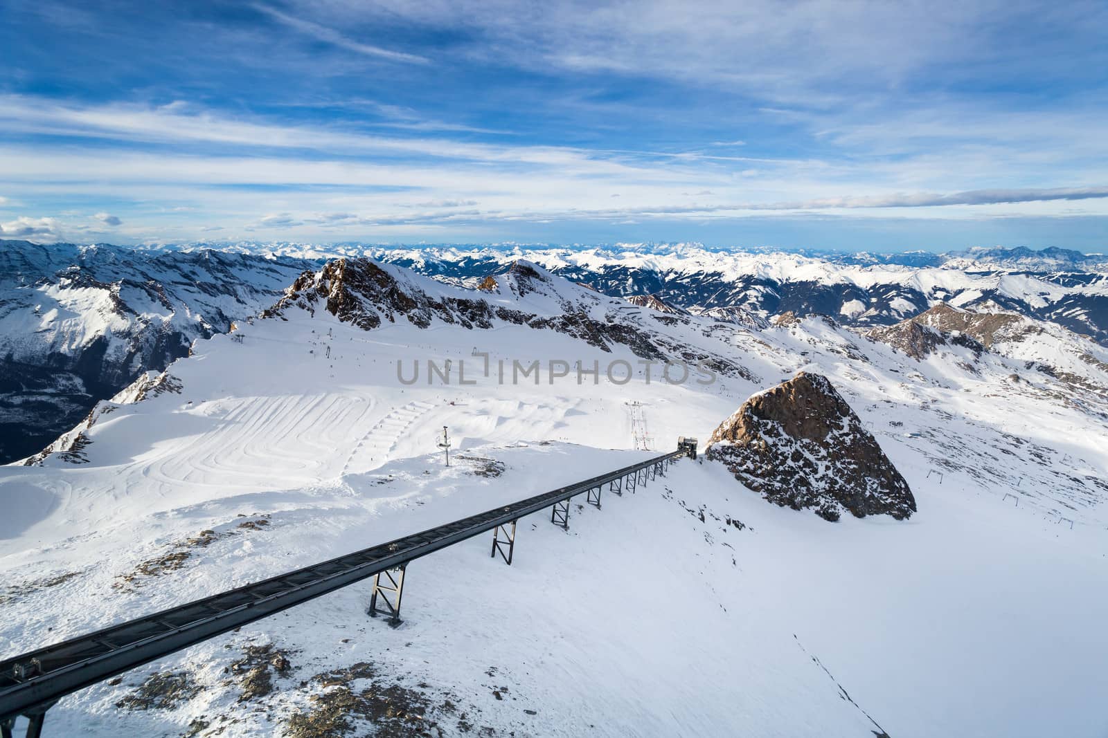 Winter with ski slopes of kaprun resort next to kitzsteinhorn peak in austrian alps