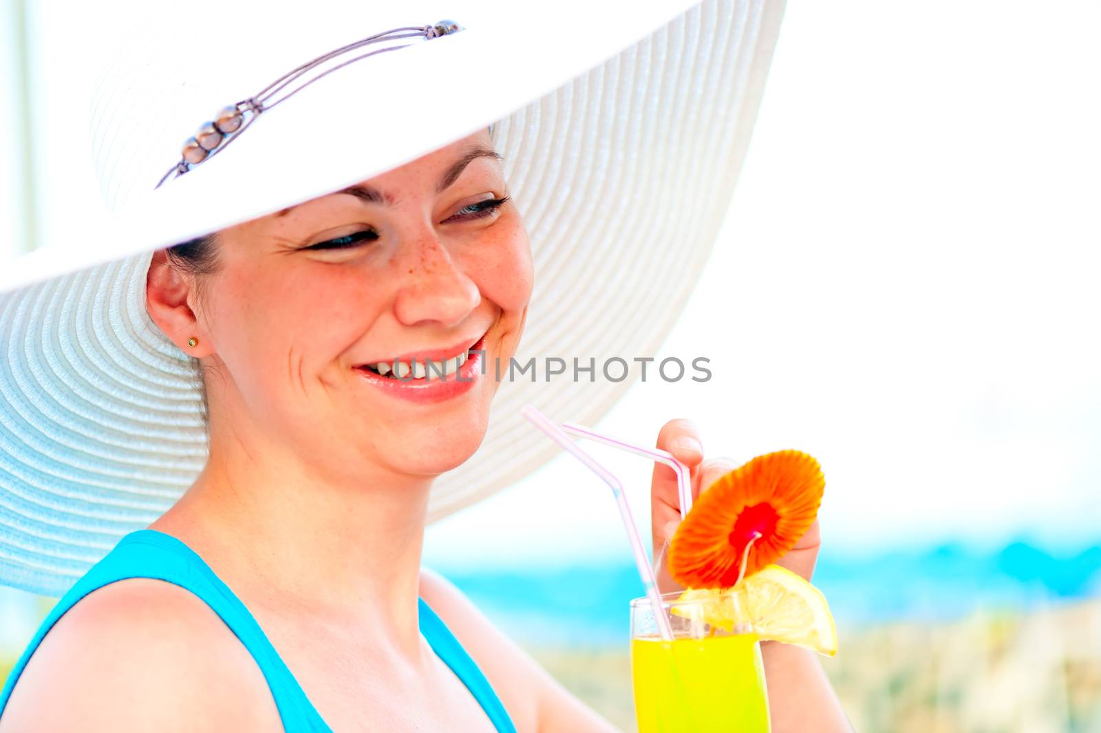 beautiful carefree girl in white hat with a cocktail in hand by kosmsos111