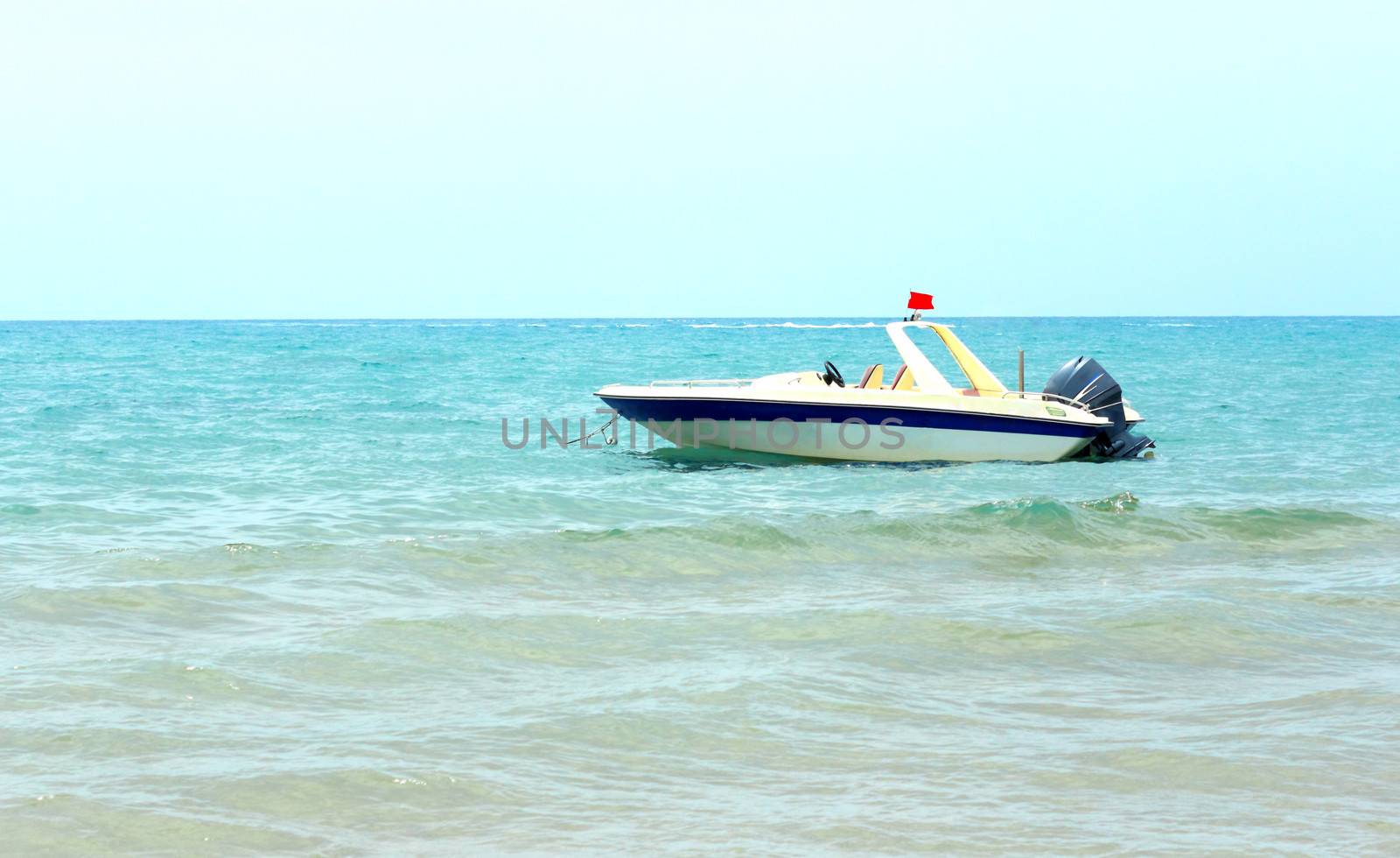 The small boat for sea trips in the coastal waters near the beach at the resort.