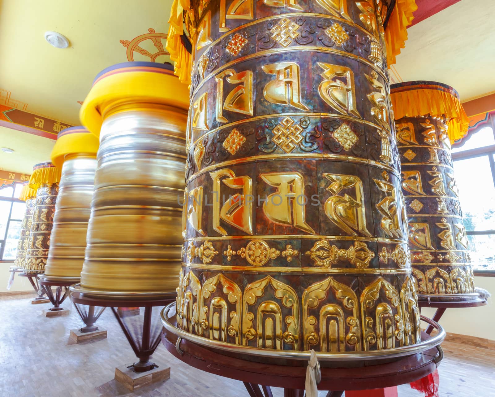 Buddhist prayer wheels in Tibetan monastery with written mantra, Yoksom, Sikkim, India.