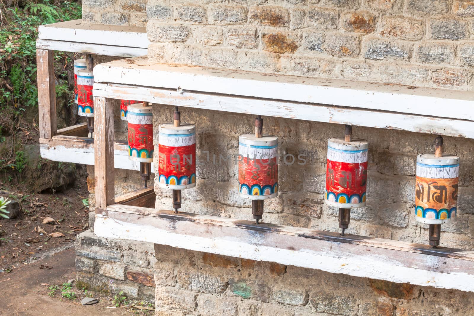 Buddhist prayer wheels in Tibetan monastery with written mantra, Yoksom, Sikkim, India.