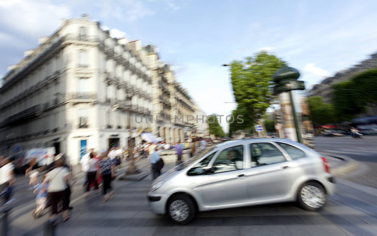 Blurred expresion of a car and peole down the Champs Elysees, Paris