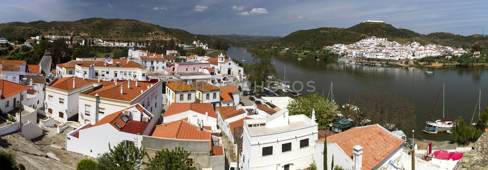 Far view of Sanlucar town in the Guadiana river located in Spain taken from Alcoutim town in Portugal.