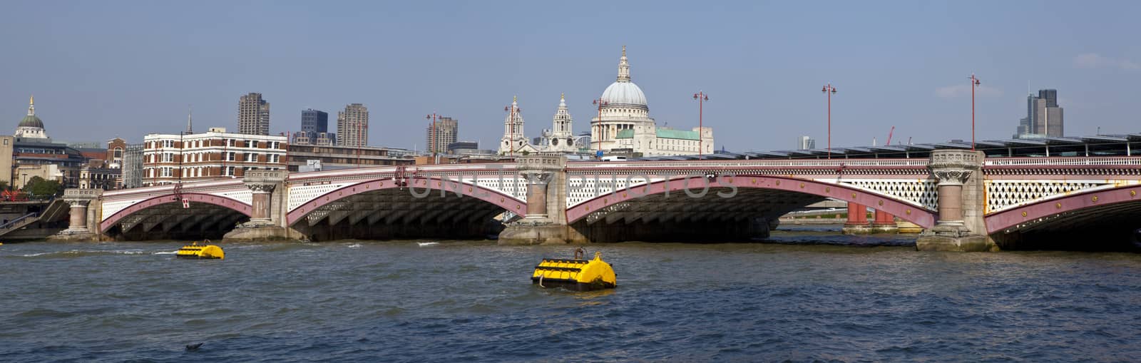 Blackfriars Bridge in London.  The dome and towers of St. Paul's Cathedral are in the distance.