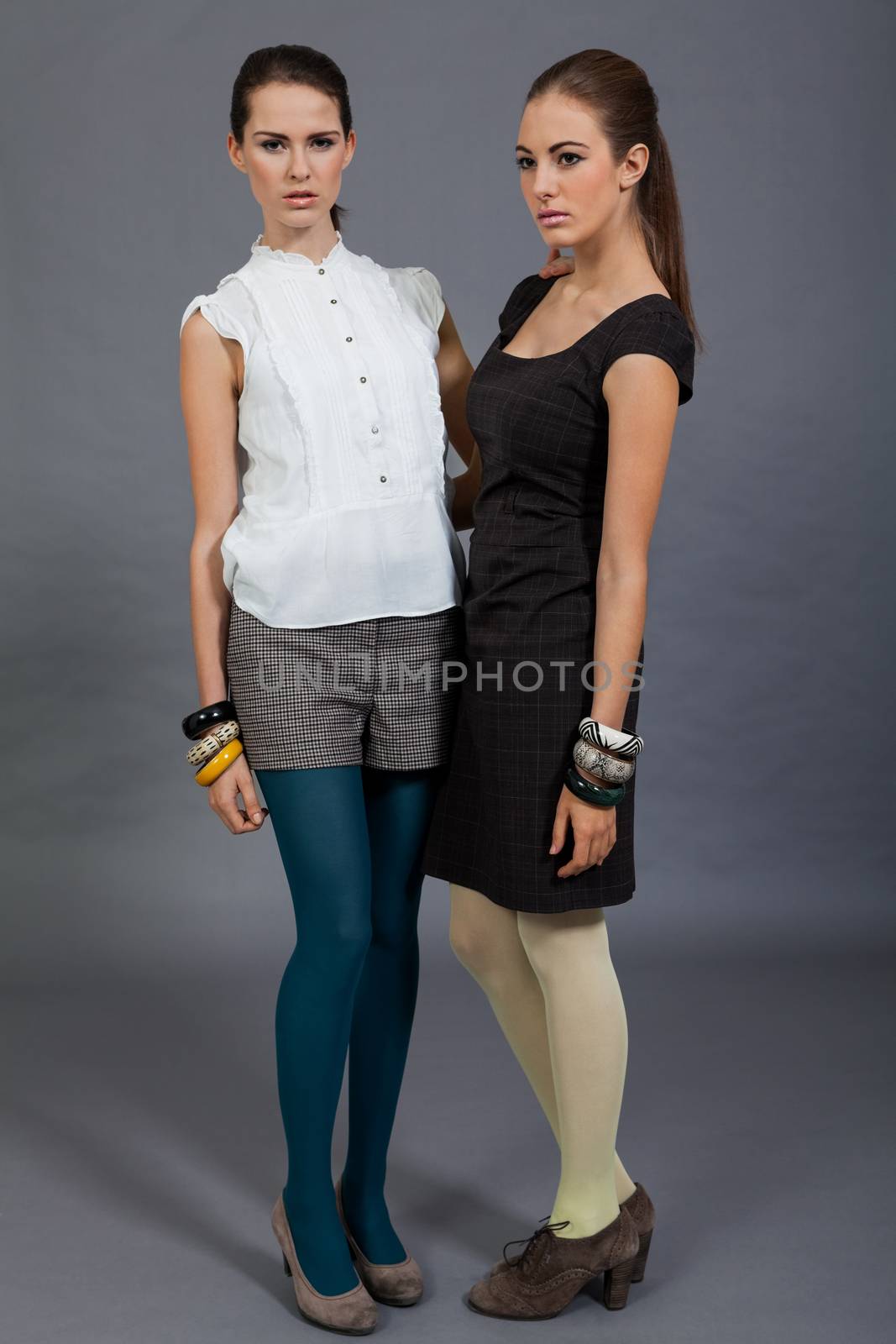 two beutiful brunette girls in casual fashion and accessory  portrait