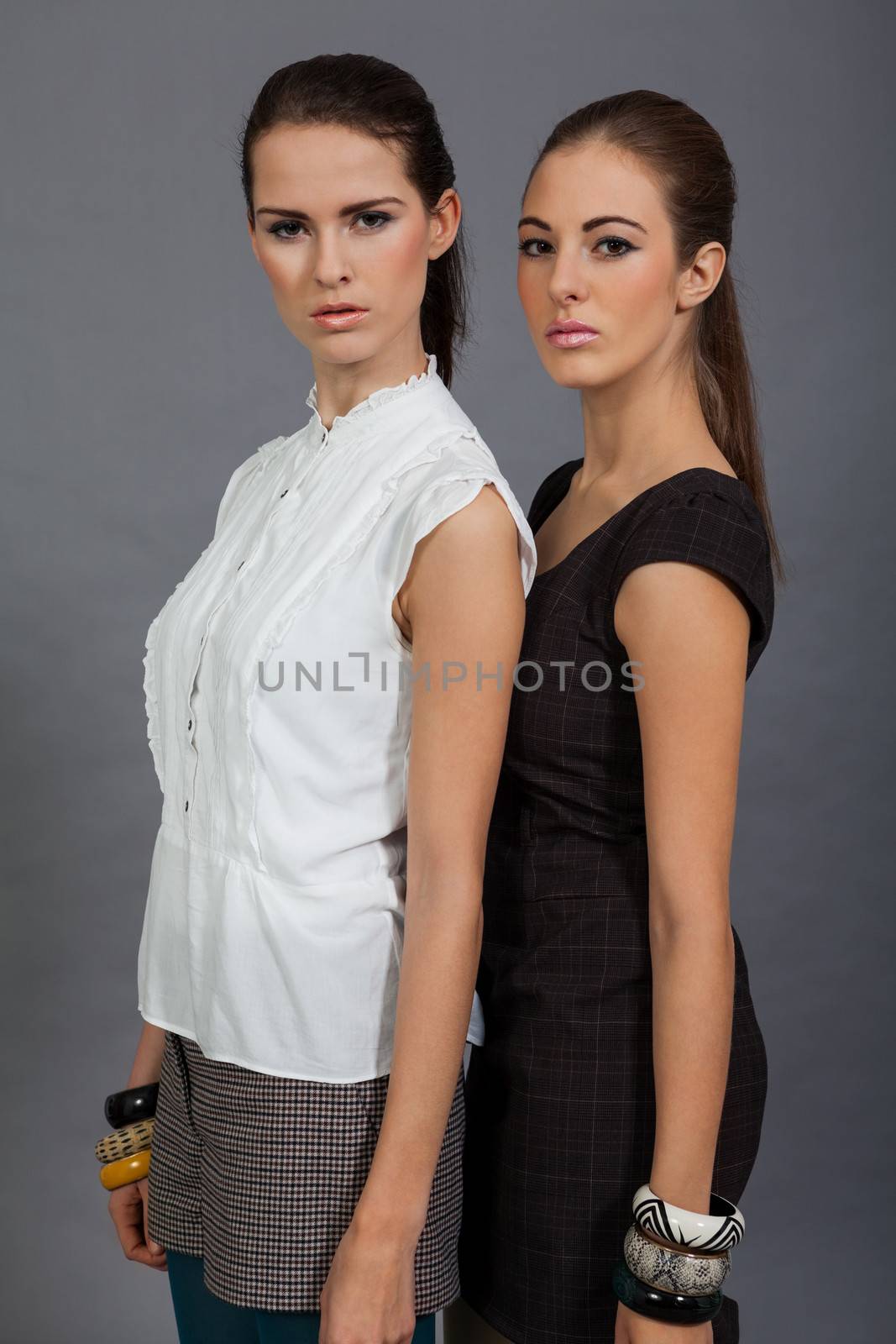 two beutiful brunette girls in casual fashion and accessory  portrait