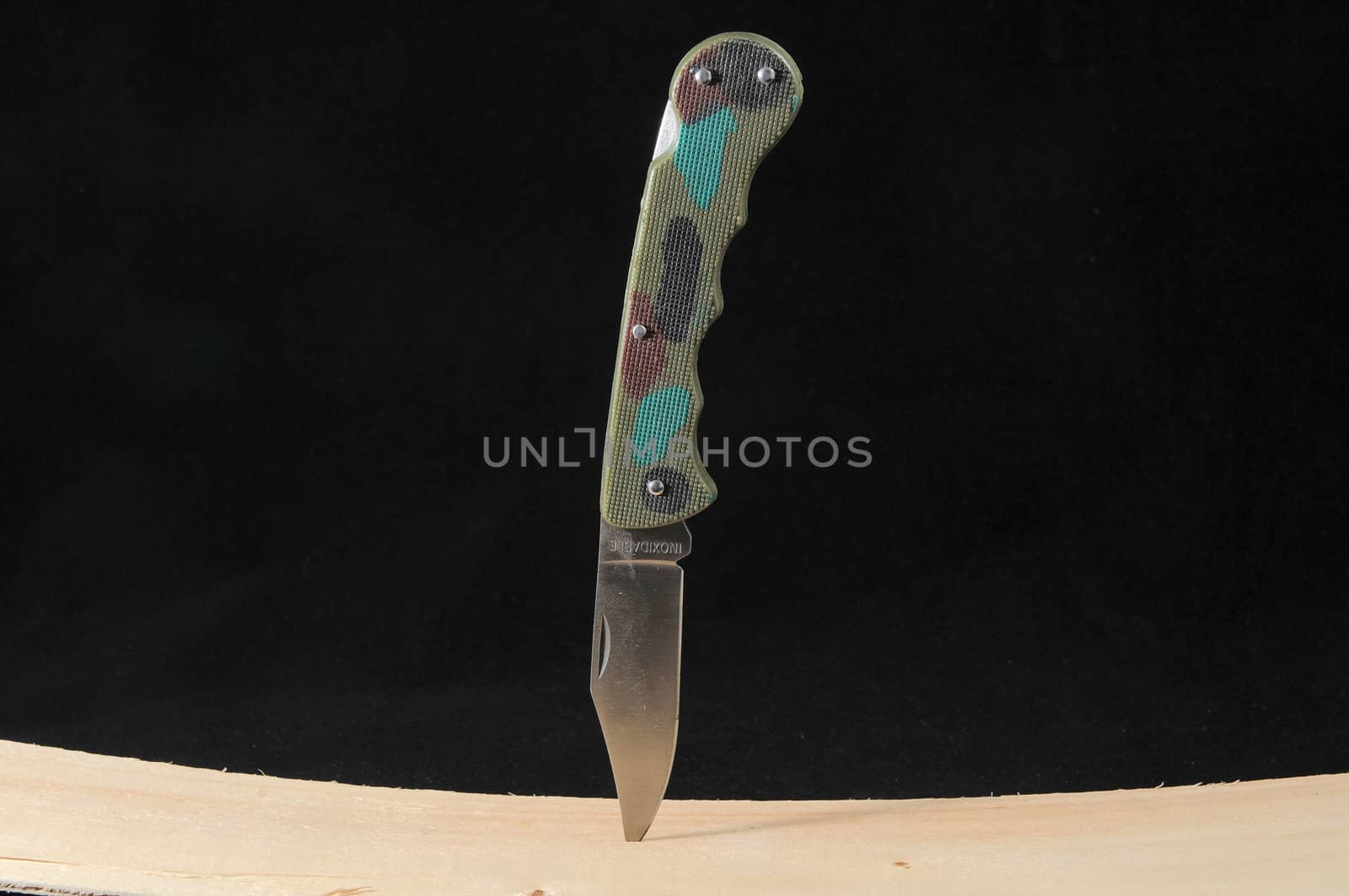 A Mimetic Hunting Knife on a Black Background