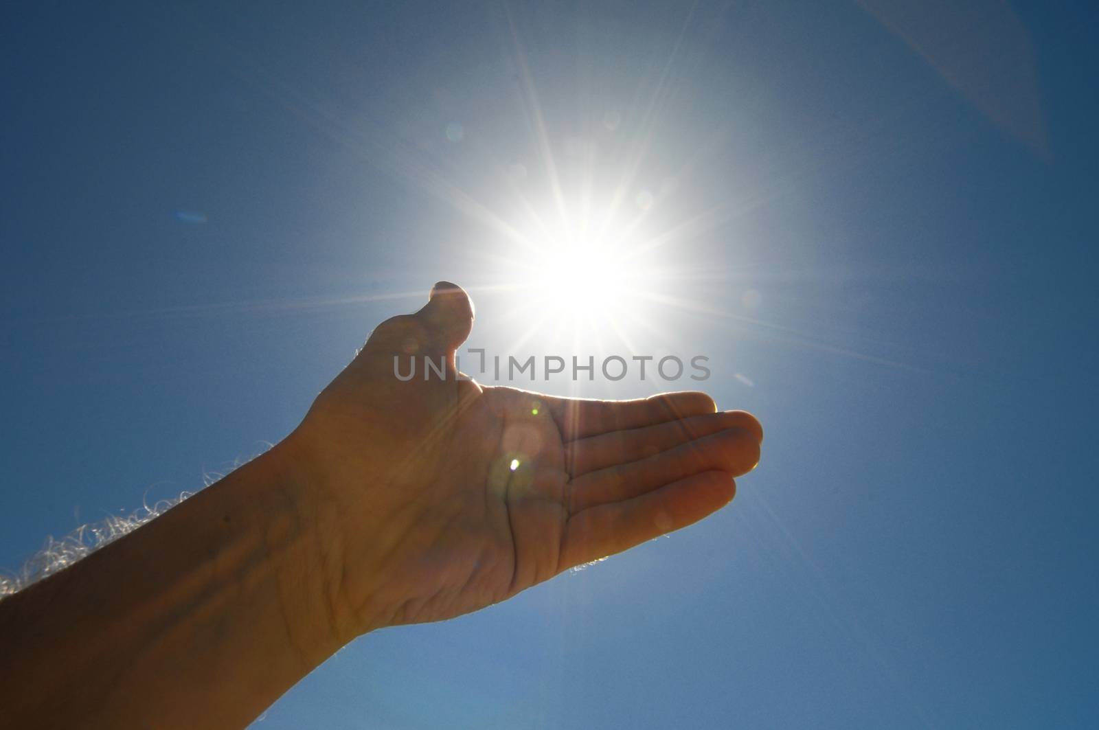 One Hand Catching the Sun Stars on a Blue Background by underworld