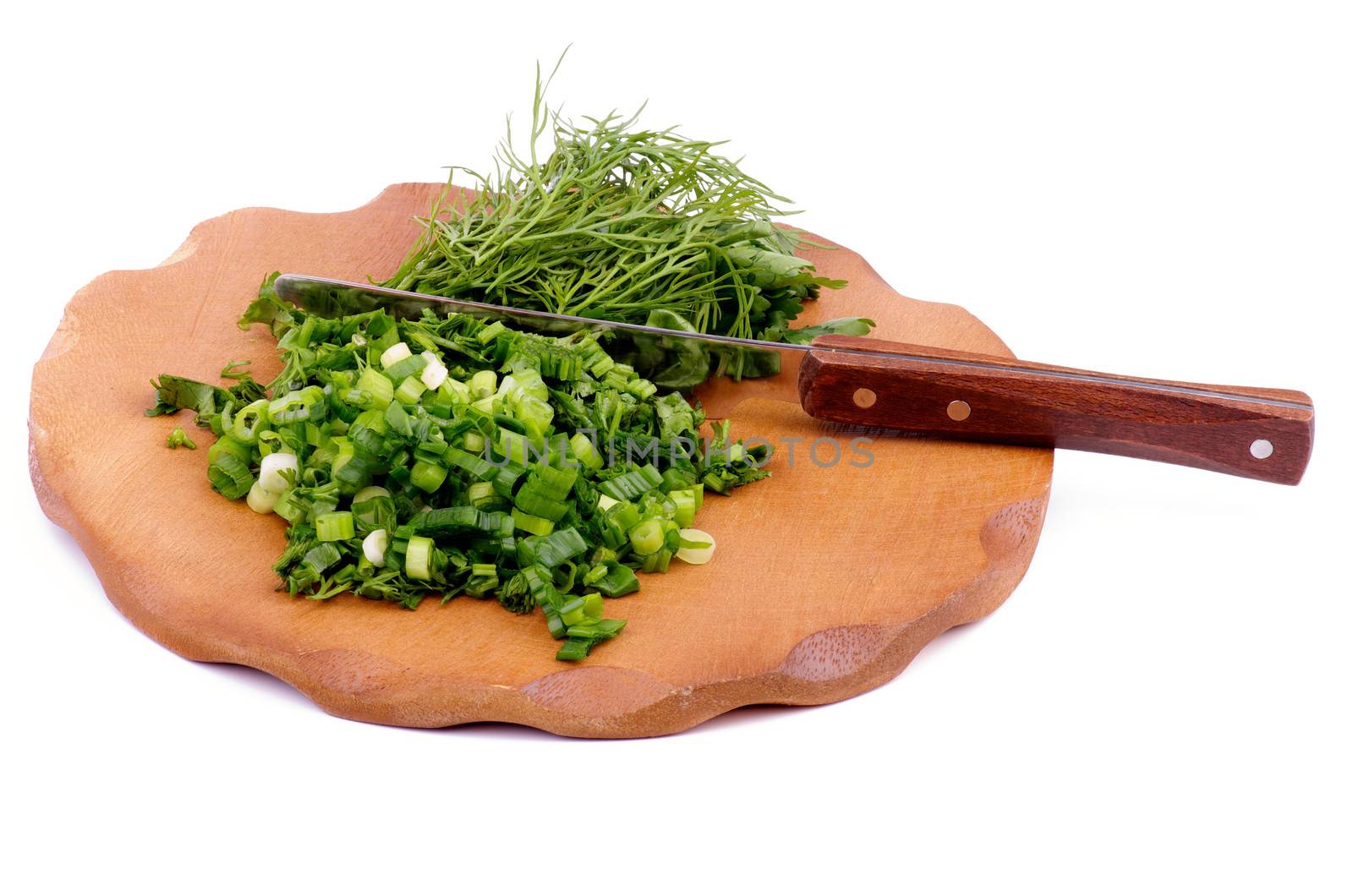 Wooden Cutting Board with Chopped Chives, Parsley, Dill and Table Knife isolated on white background