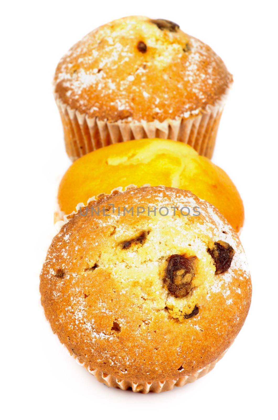 Tasty Homemade Muffins with Raisins and Sugar Powder In a Row isolated on white background