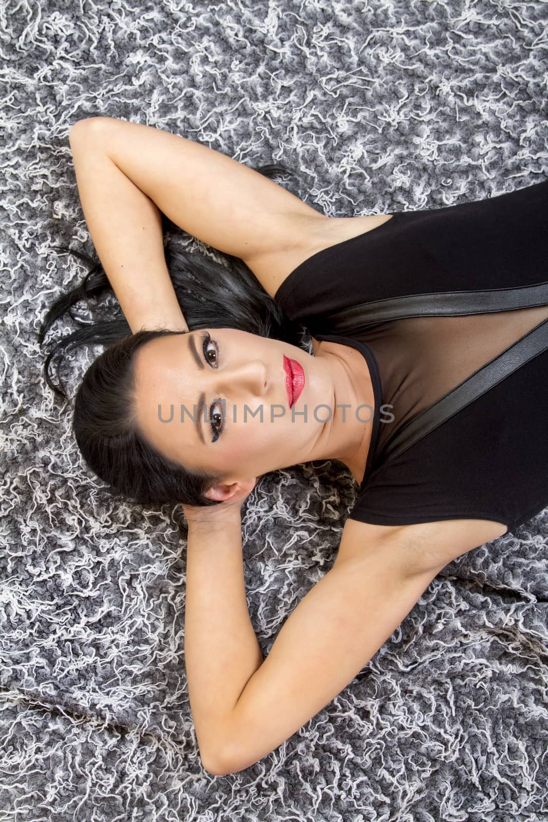 beautiful young woman posing on top of a cool carpet by membio