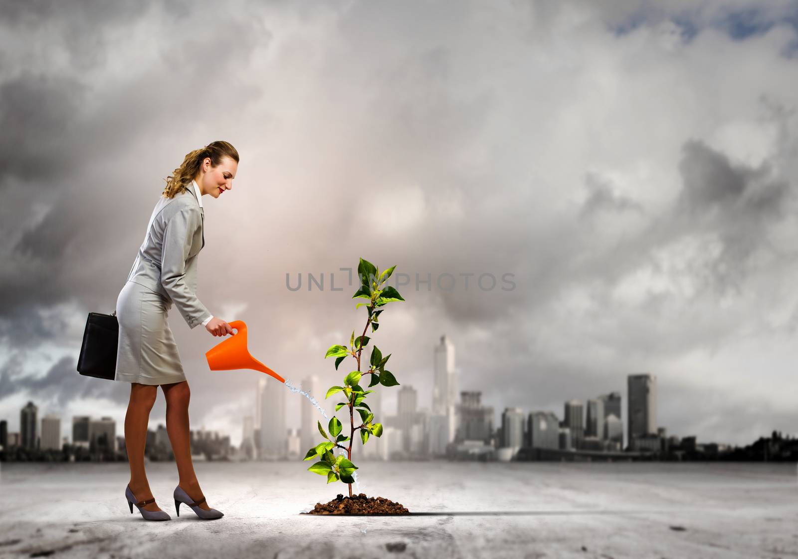Image of businesswoman watering tree with pot. Ecology concept