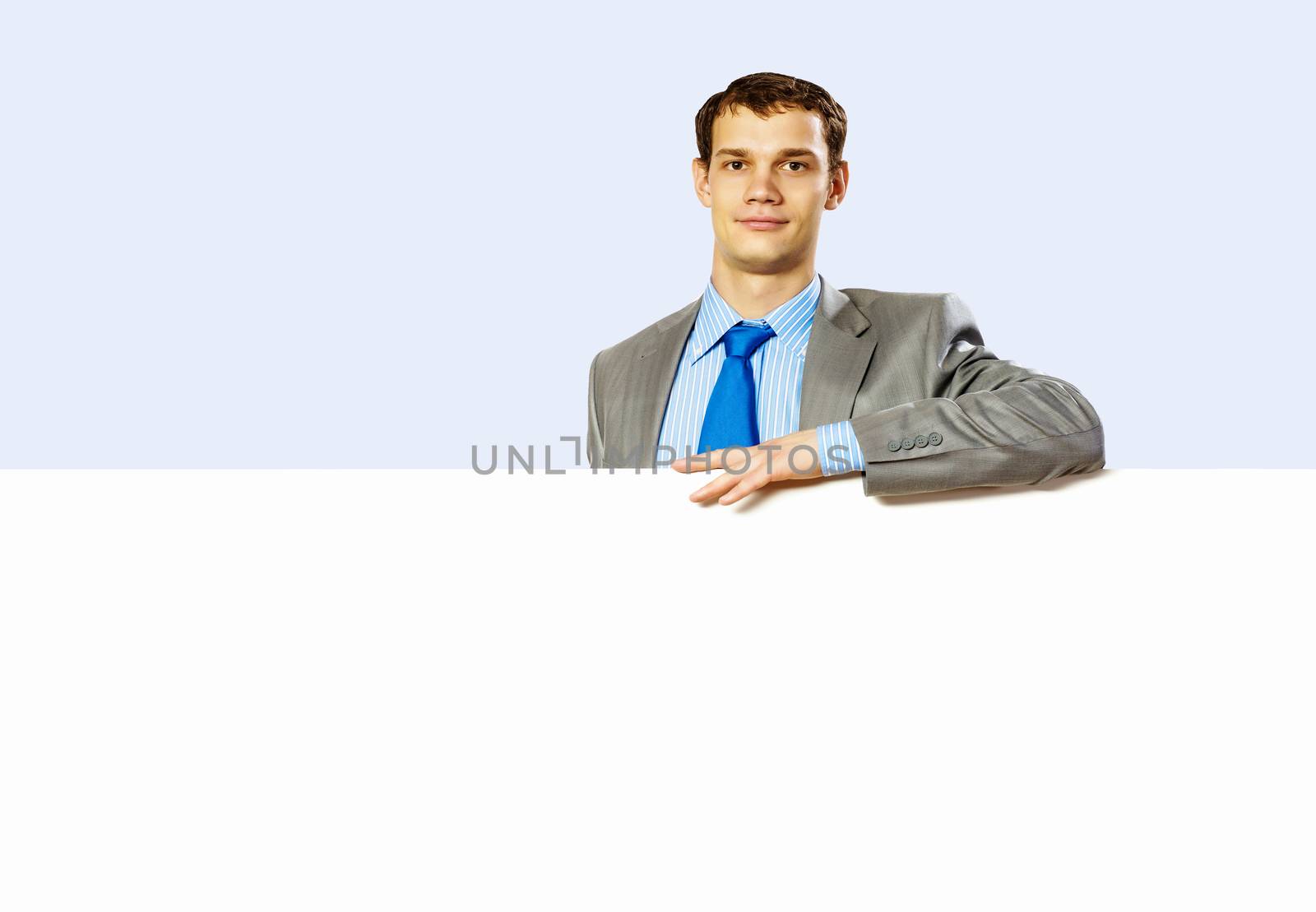 Businessman holding blank banner by sergey_nivens