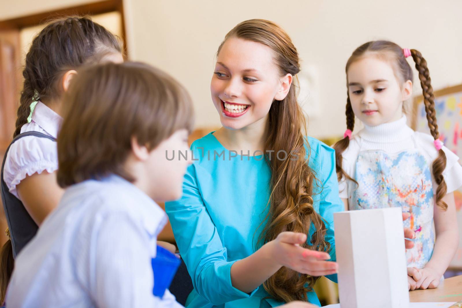 Little children painting and playing at kindergarten