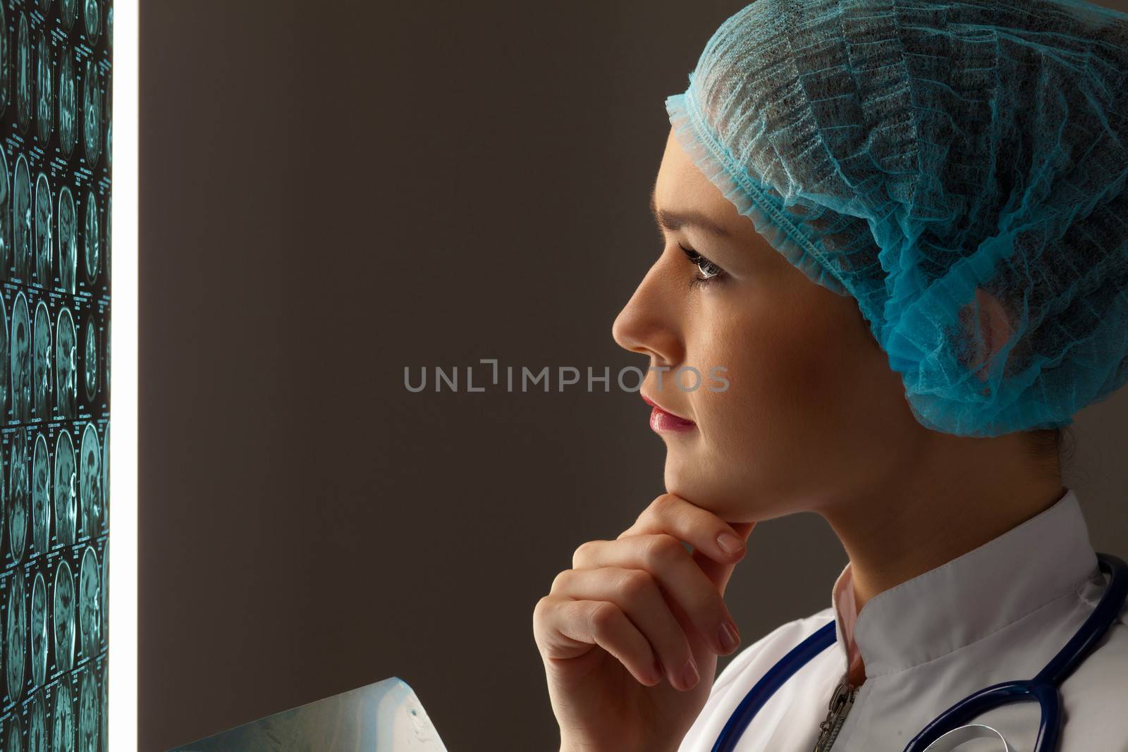 Image of attractive woman doctor looking at x-ray results