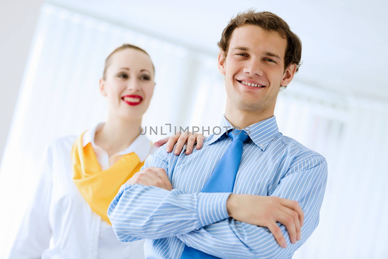 Image of businessman and businesswoman smiling joyfully